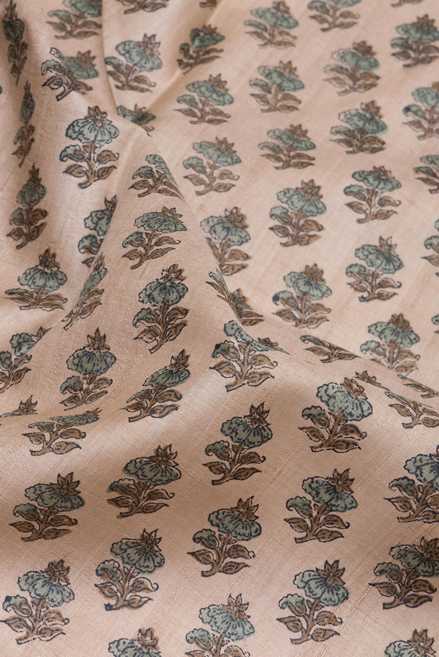 Close up of Beige Tussar Silk Saree with Printed design on the body and Printed Border.  displaying folds