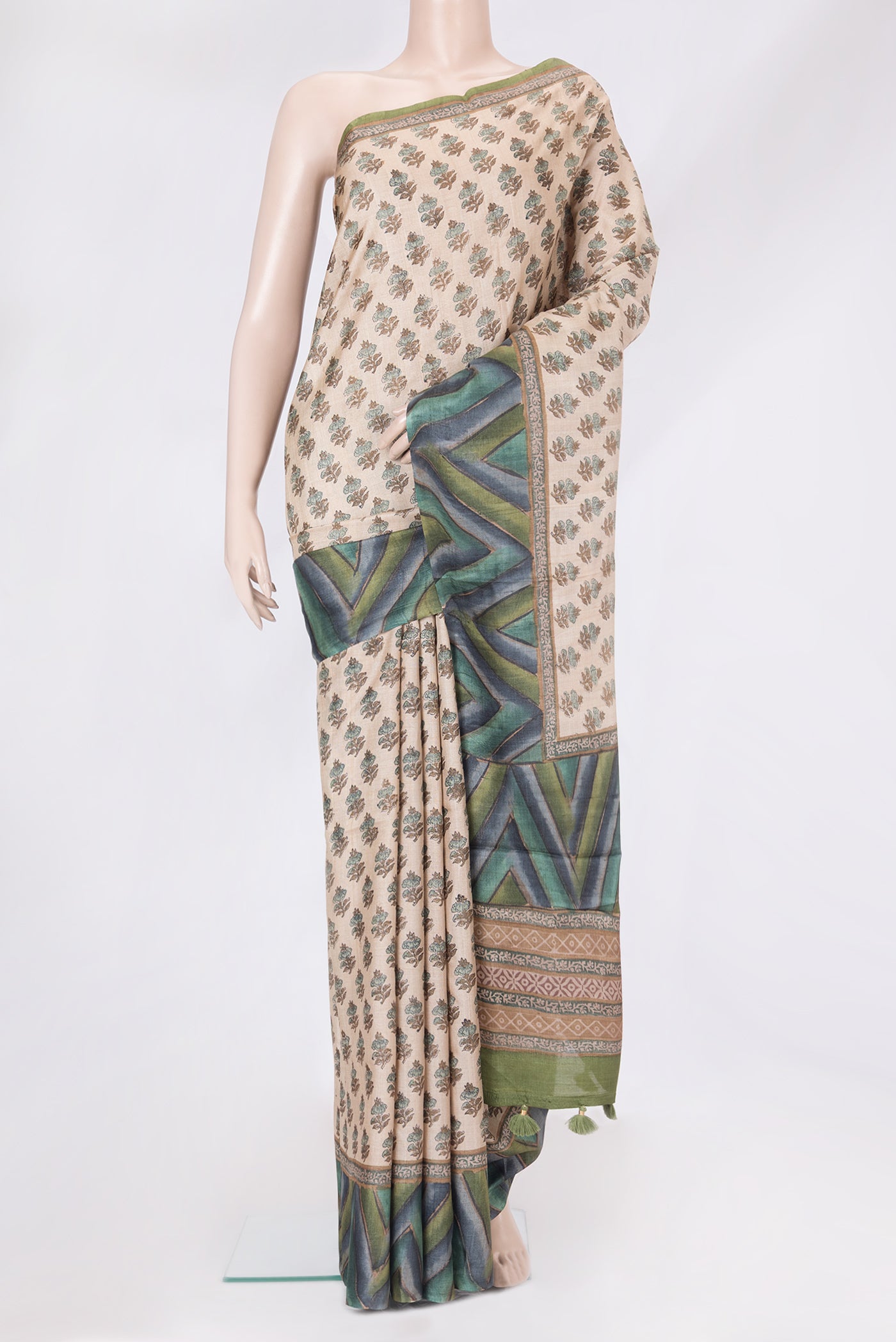Beige Tussar Silk Saree with Printed design on the body and Printed Border.  displayed on a mannequin