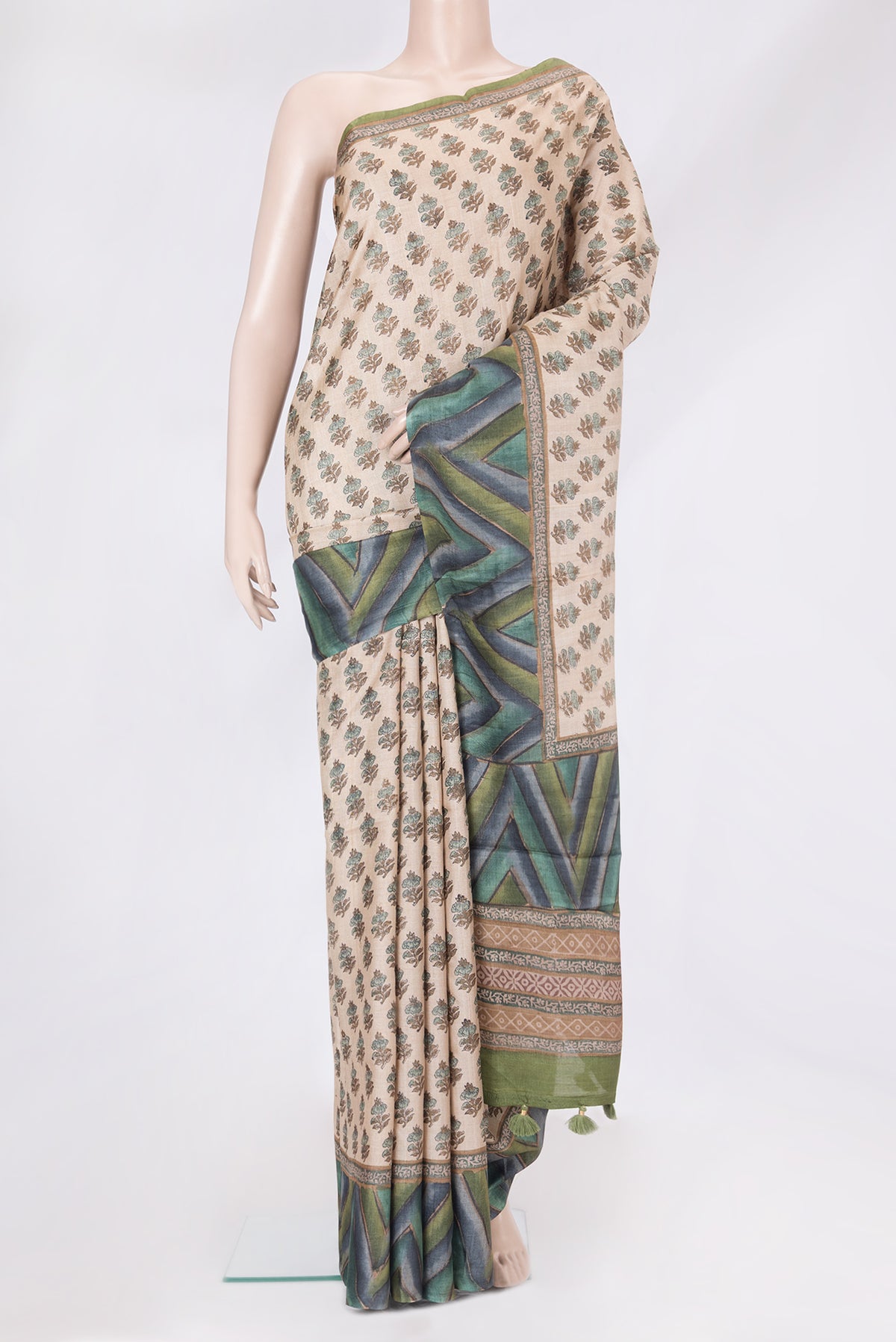 Beige Tussar Silk Saree with Printed design on the body and Printed Border.  displayed on a mannequin