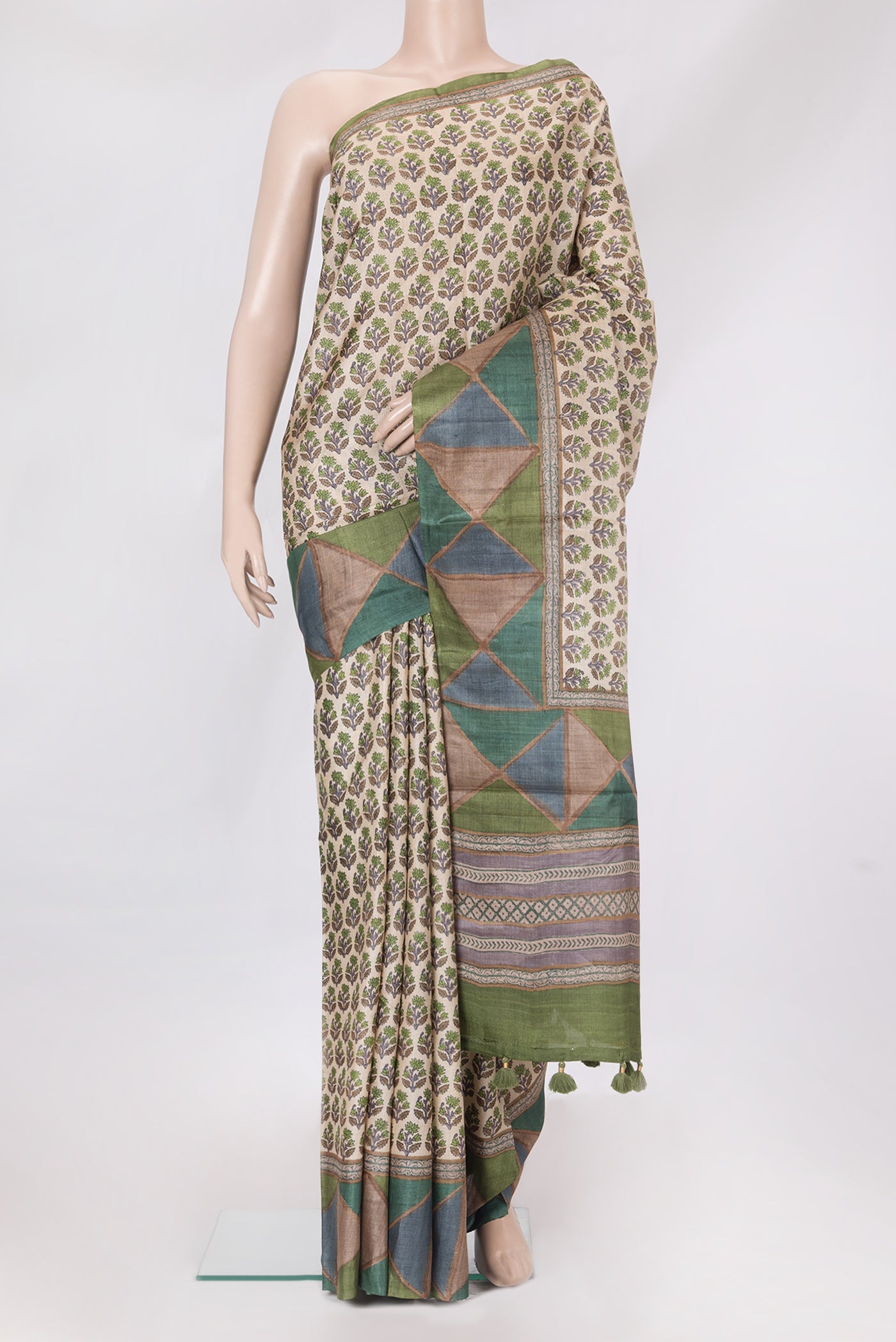 Beige Tussar Silk Saree with Printed design on the body and Fancy Border.  displayed on a mannequin