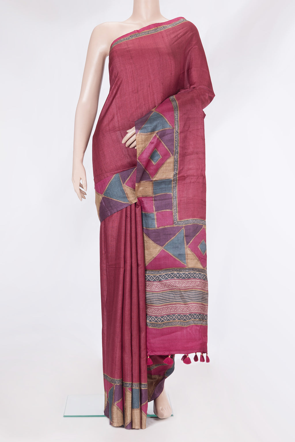 Maroon Tussar Silk Saree with Plain Body and Fancy Border.  displayed on a mannequin