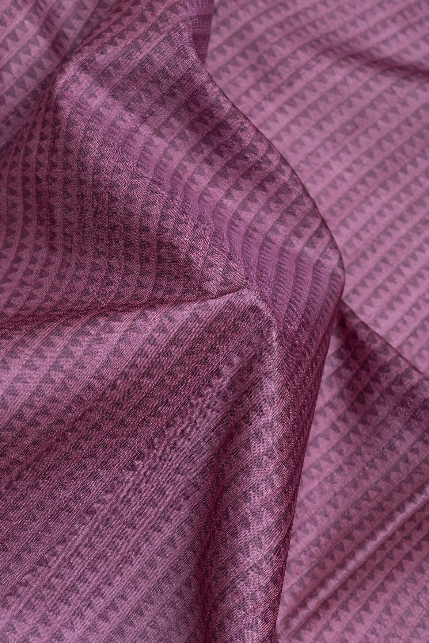Close up of Purple Tussar Silk Saree with Printed design on the body and Fancy Border.  displaying folds