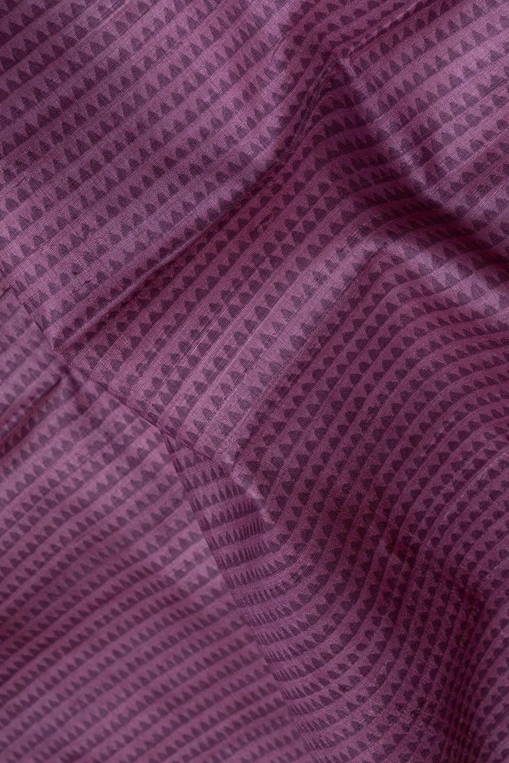 Close up of Purple Tussar Silk Saree with Printed design on the body and Printed Border.  displaying folds