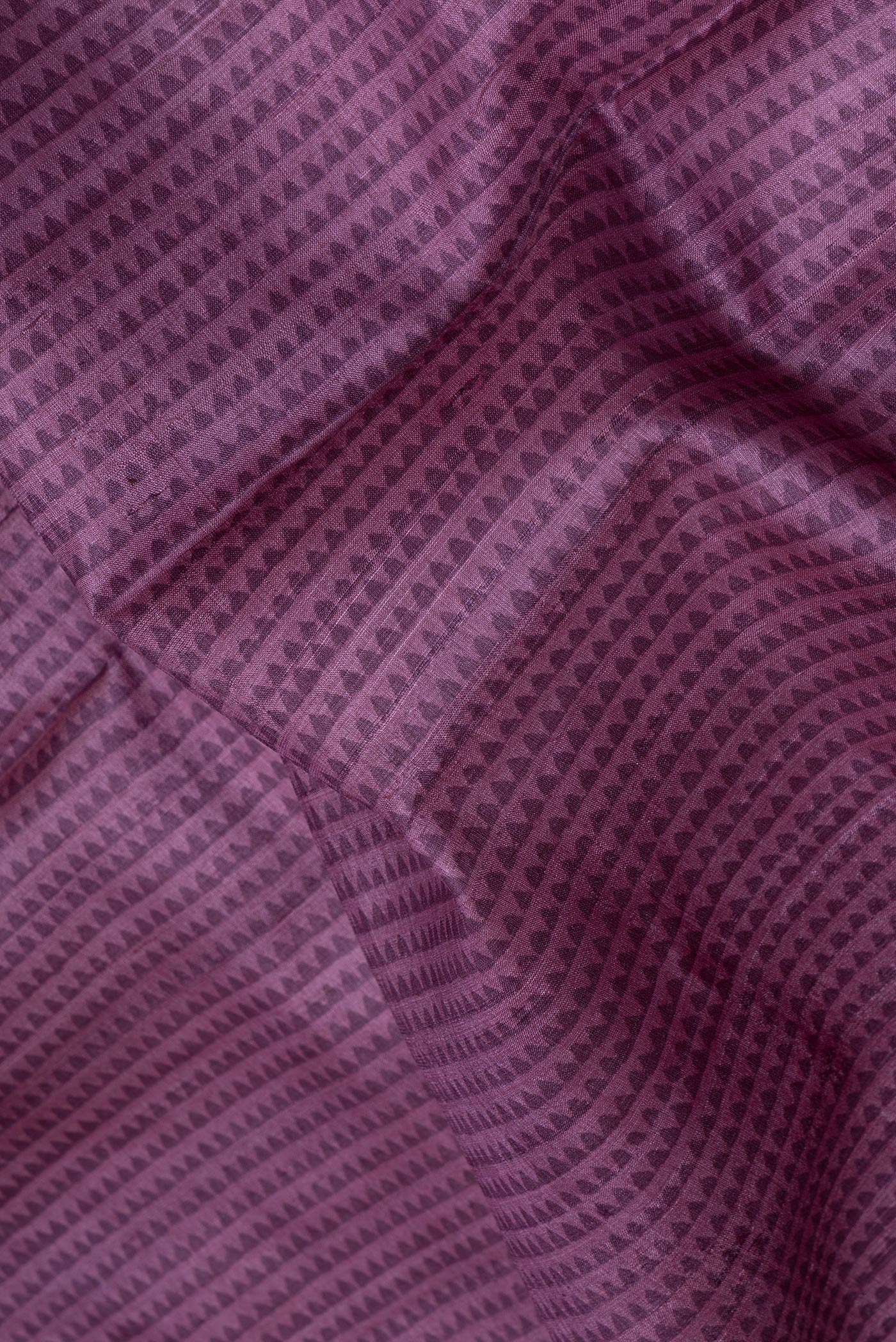 Close up of Purple Tussar Silk Saree with Printed design on the body and Printed Border.  displaying folds