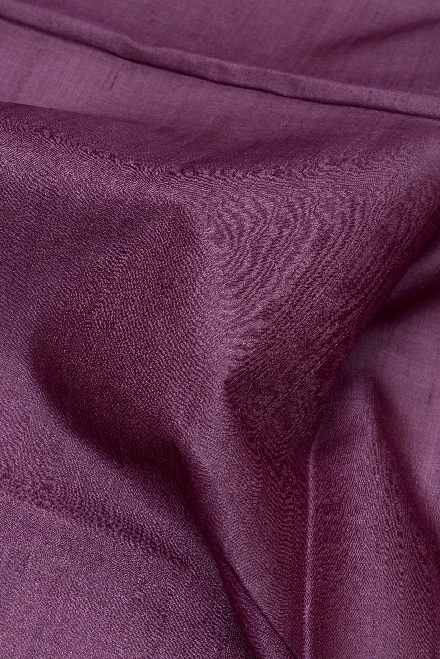 Close up of Purple Tussar Silk Saree with Plain Body and Fancy Border.  displaying folds