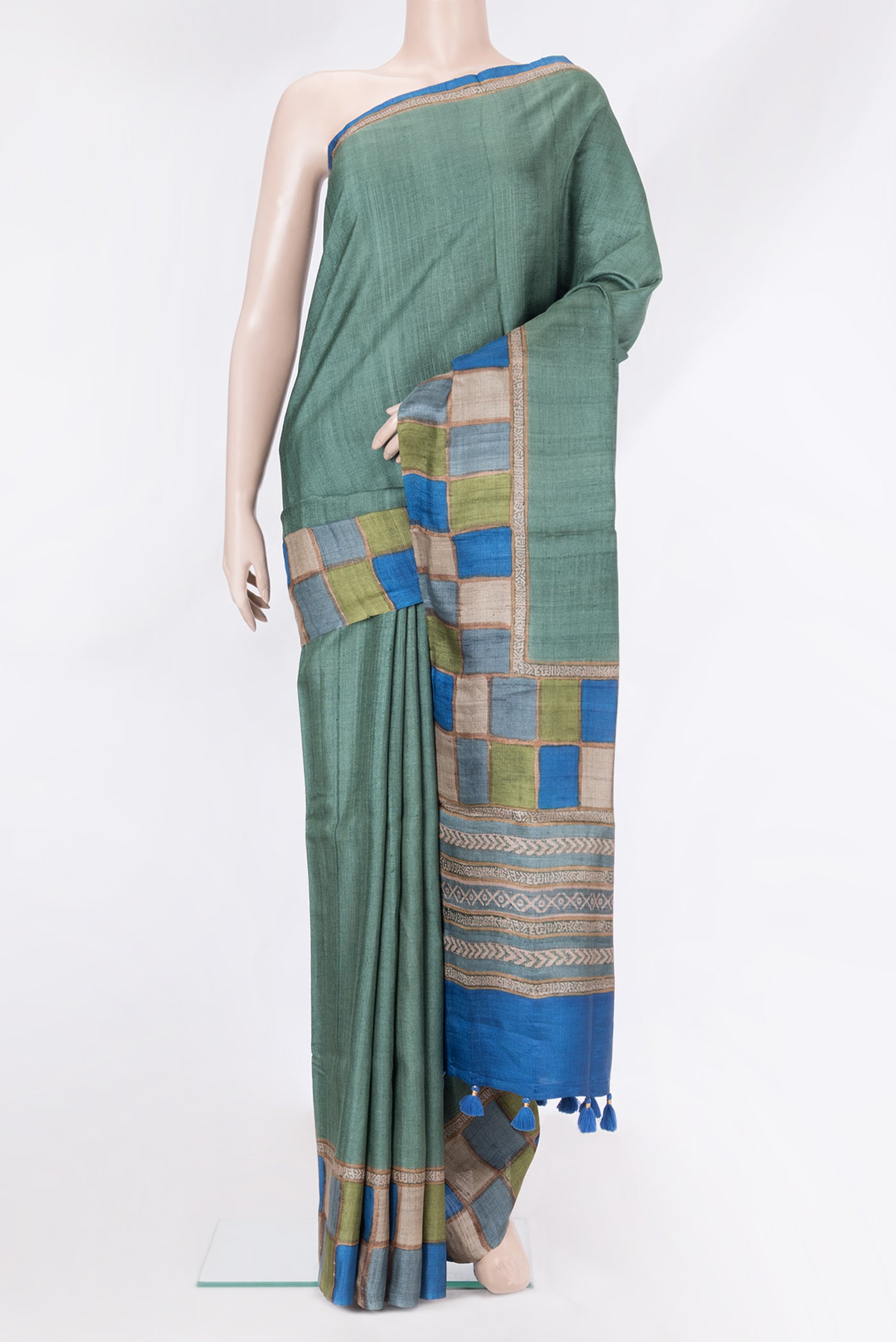 Green Tussar Silk Saree with Plain Body and Fancy Border.  displayed on a mannequin