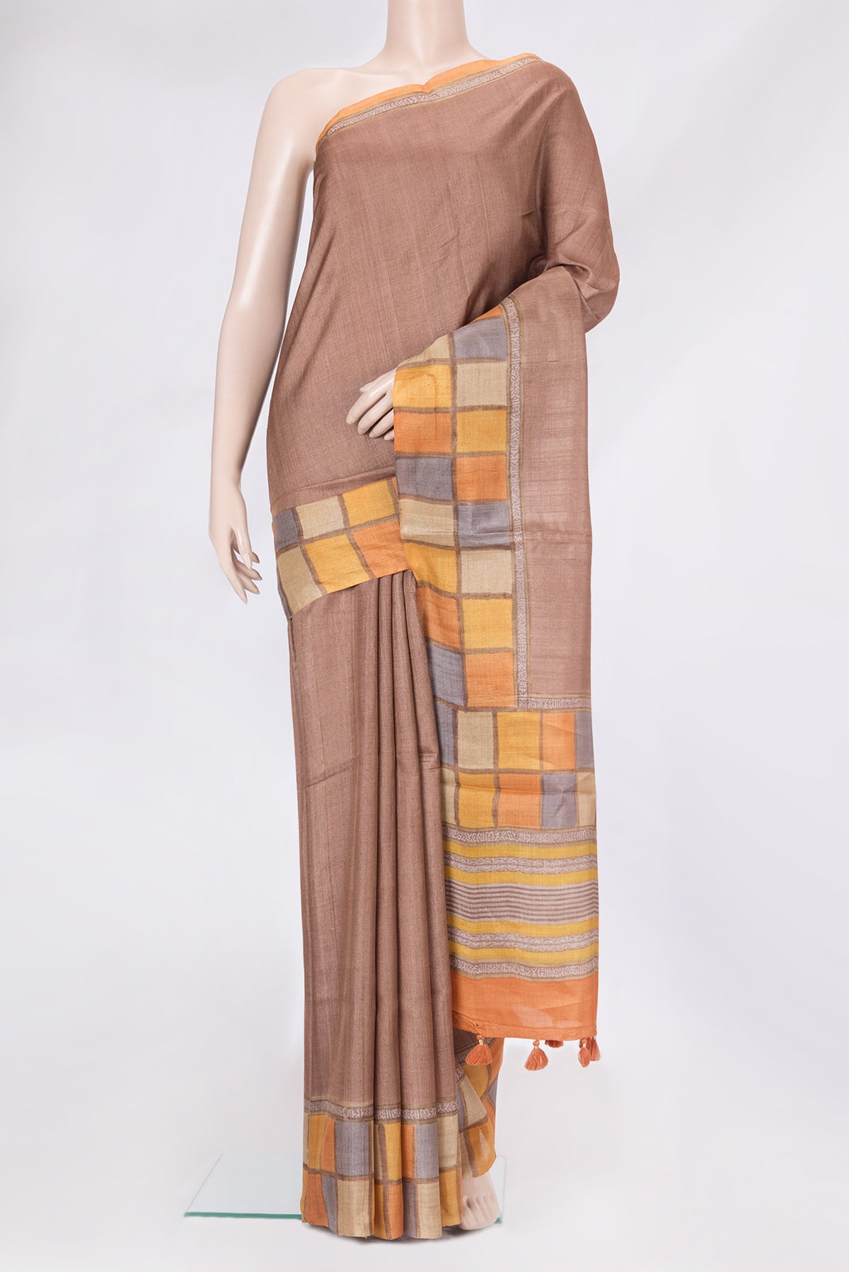 Brown Tussar Silk Saree with Plain Body and Printed Border.  displayed on a mannequin