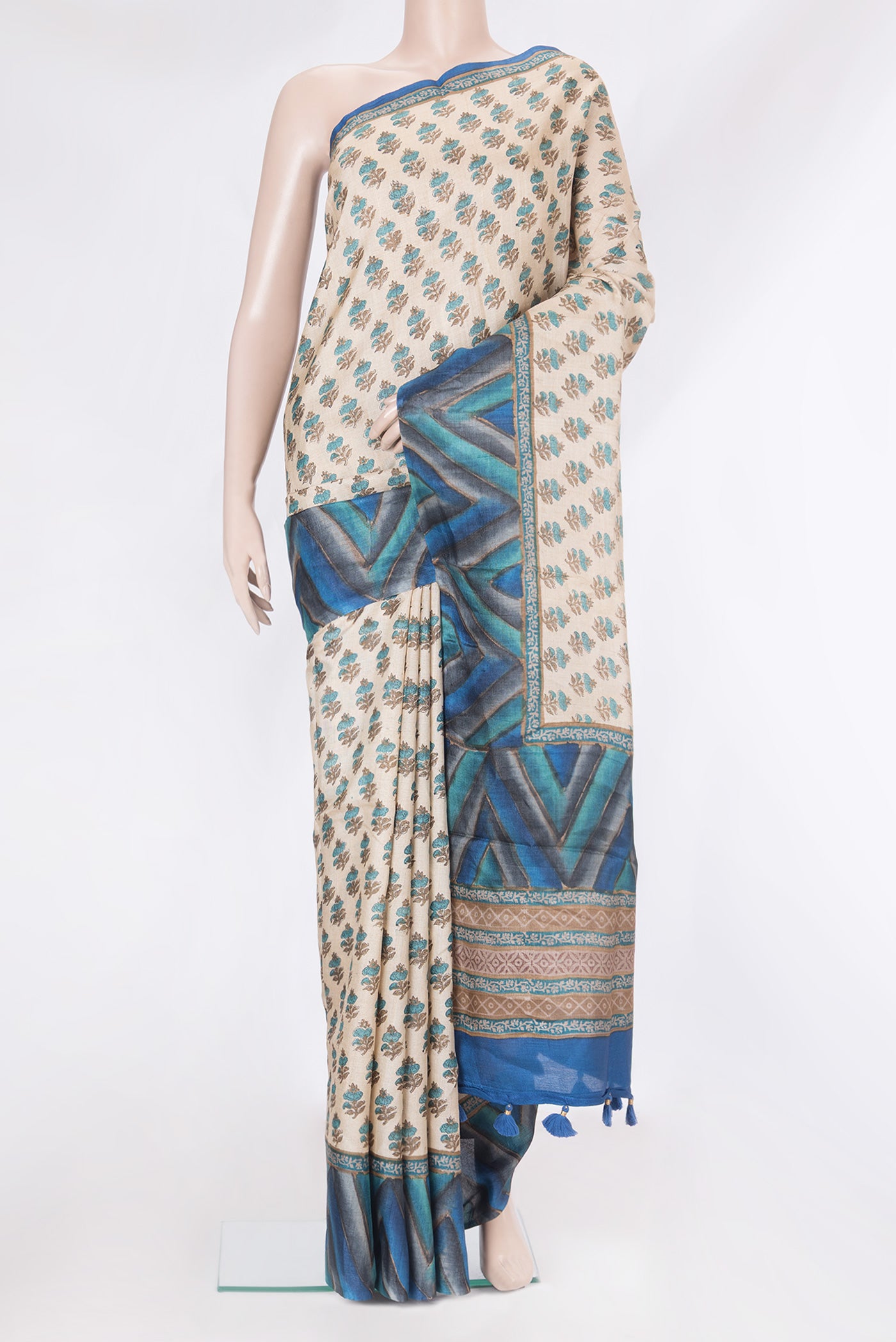 Beige Tussar Silk Saree with Printed design on the body and Fancy Border.  displayed on a mannequin
