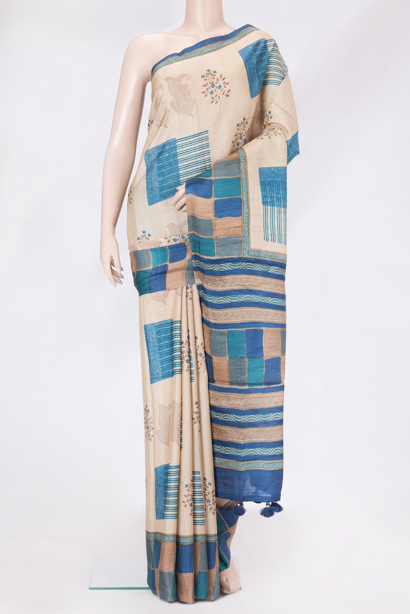 Beige Tussar Silk Saree with Printed design on the body and Printed Border.  displayed on a mannequin