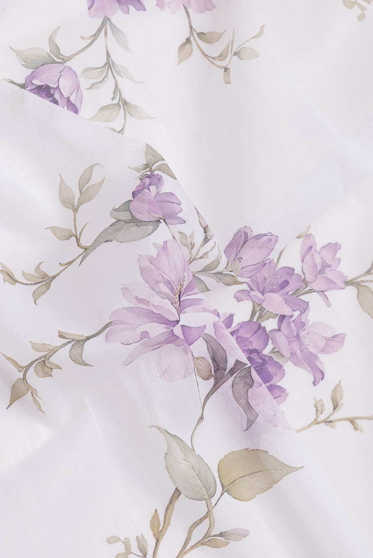 Close up of Off White Mysore Chiffon Saree with Floral Print on the body and Plain Border.  displaying folds