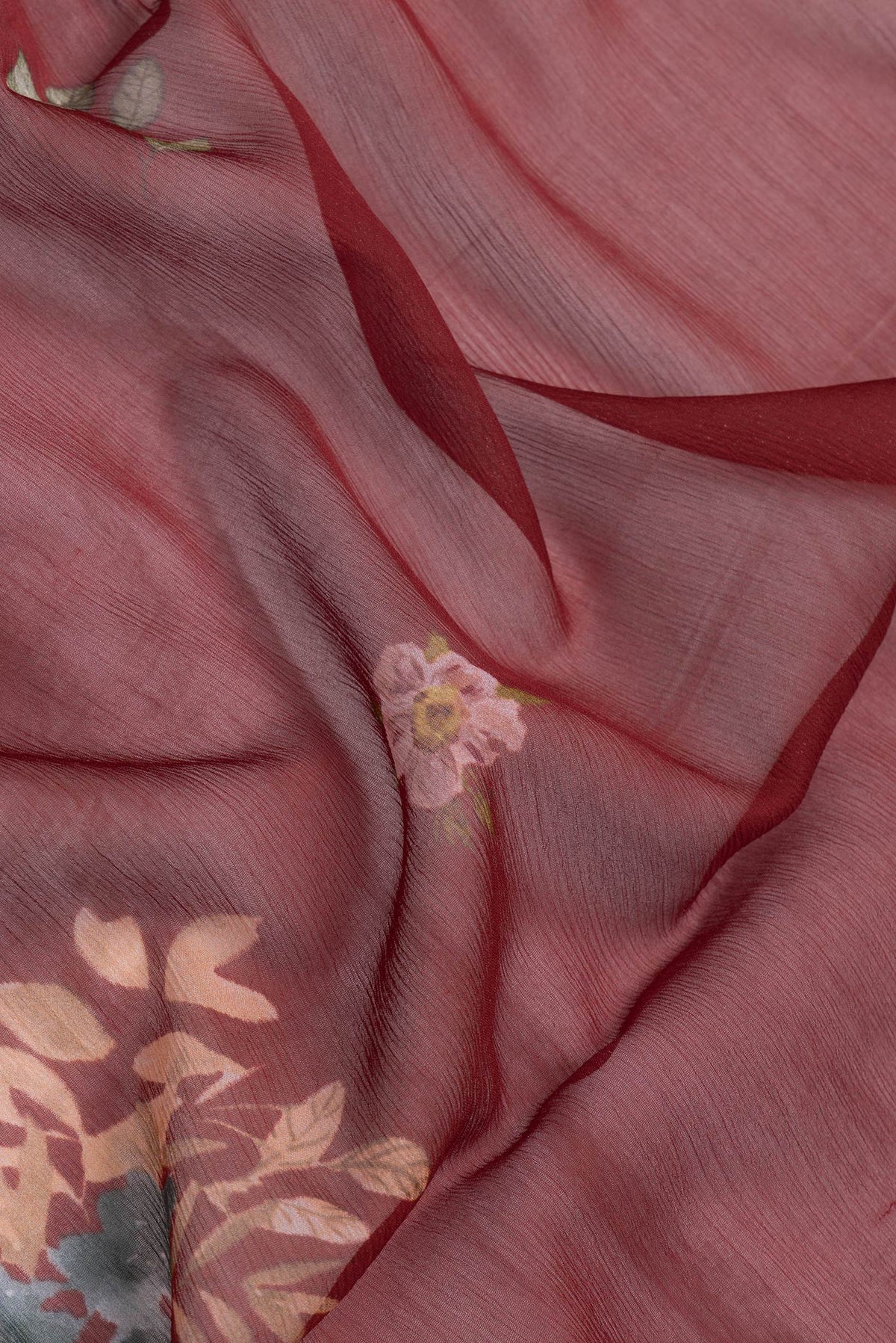 Close up of Maroon Dual Tone Mysore Chiffon Saree with Printed design on the body and Without Border.  displaying folds