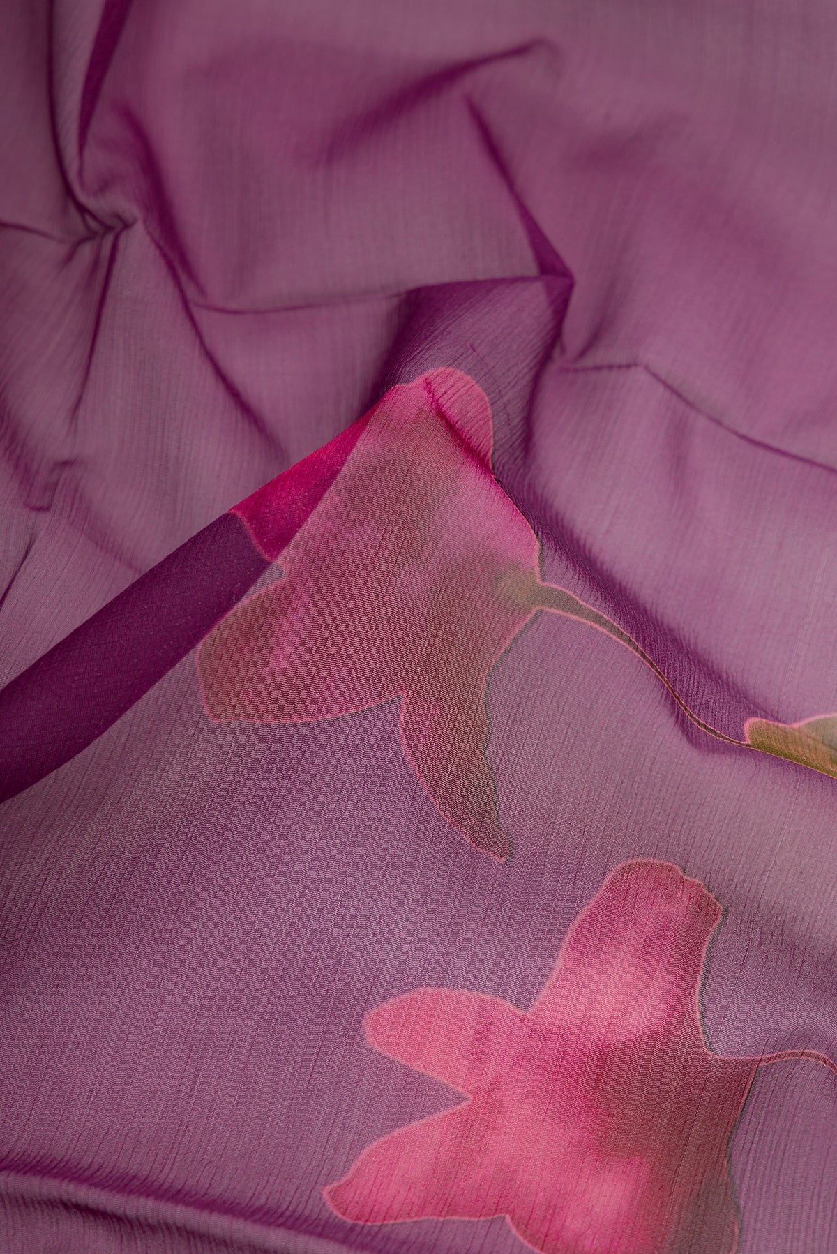 Close up of Purple Dual Tone Mysore Chiffon Saree with Printed design on the body and Without Border.  displaying folds