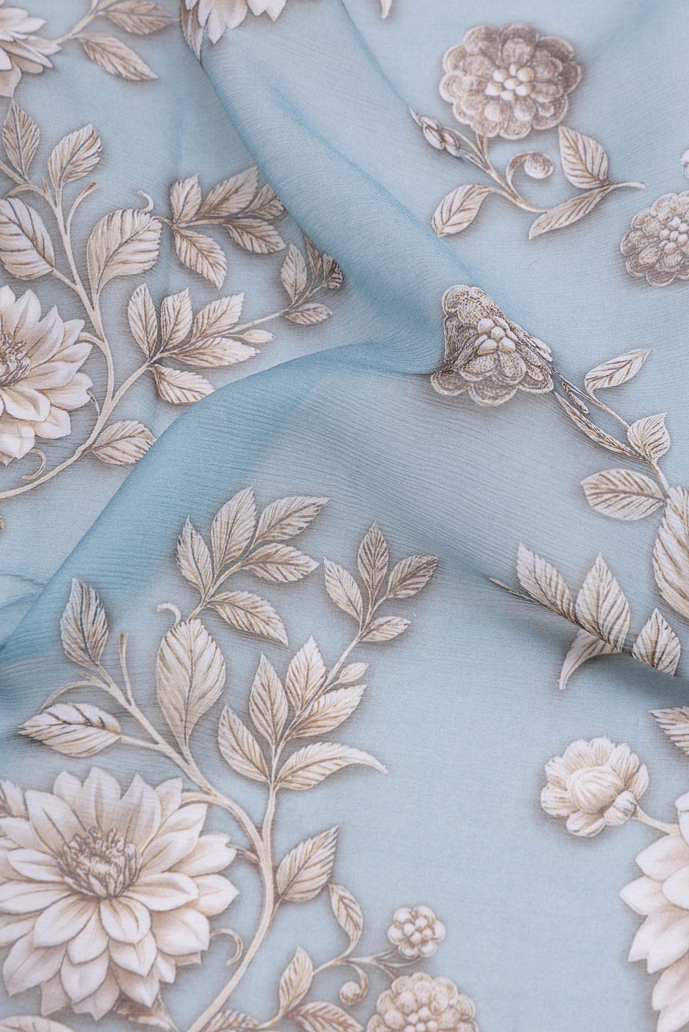Close up of Maya Blue Mysore Chiffon Saree with Floral Print on the body and Without Border.  displaying folds