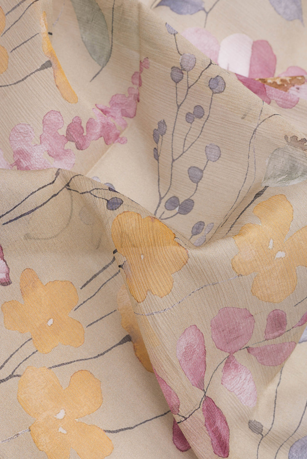 Close up of Beige Dual Tone Mysore Chiffon Saree with Printed design on the body and Plain Border.  displaying folds