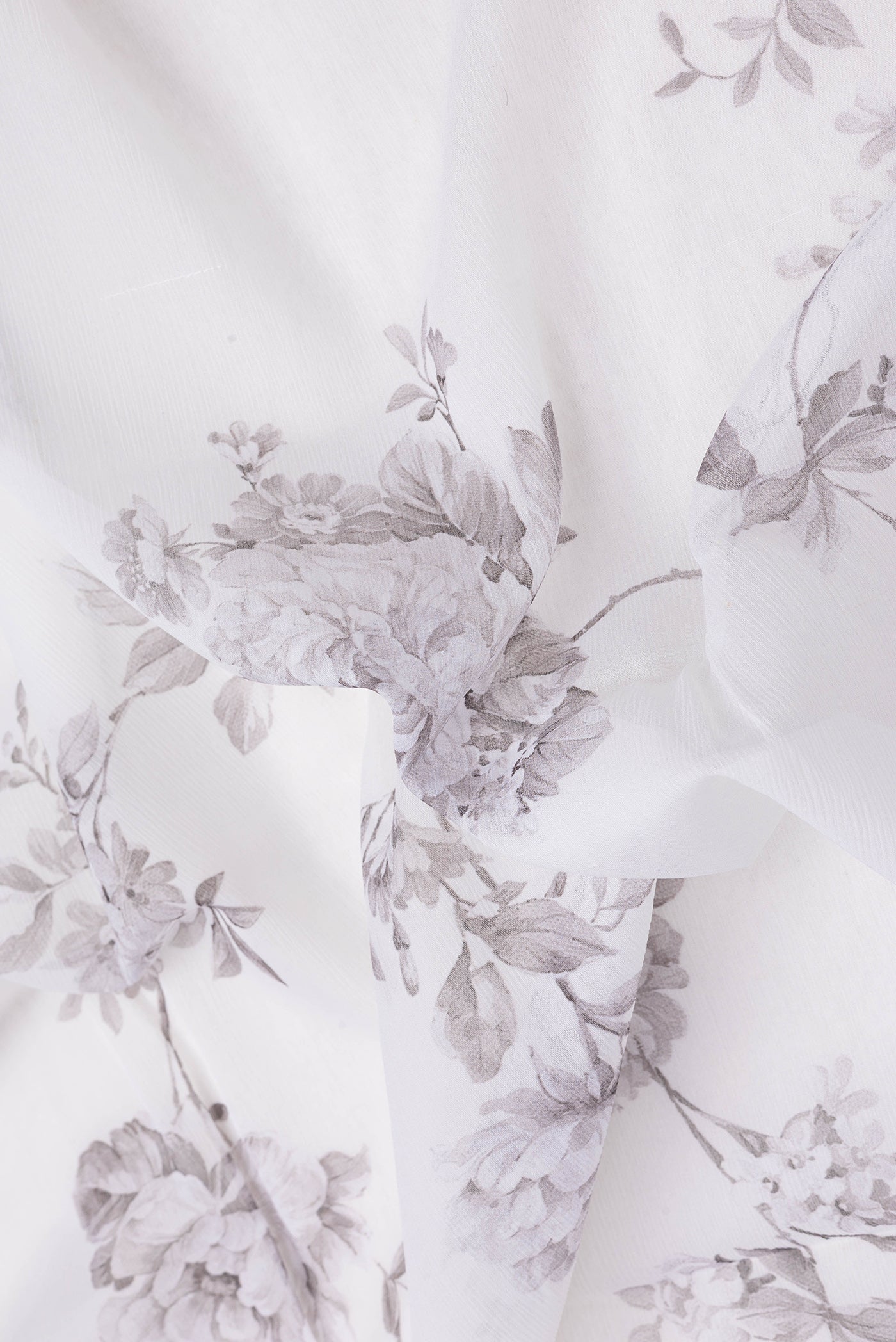 Close up of Off White Dual Tone Mysore Chiffon Saree with Printed design on the body and Plain Border.  displaying folds
