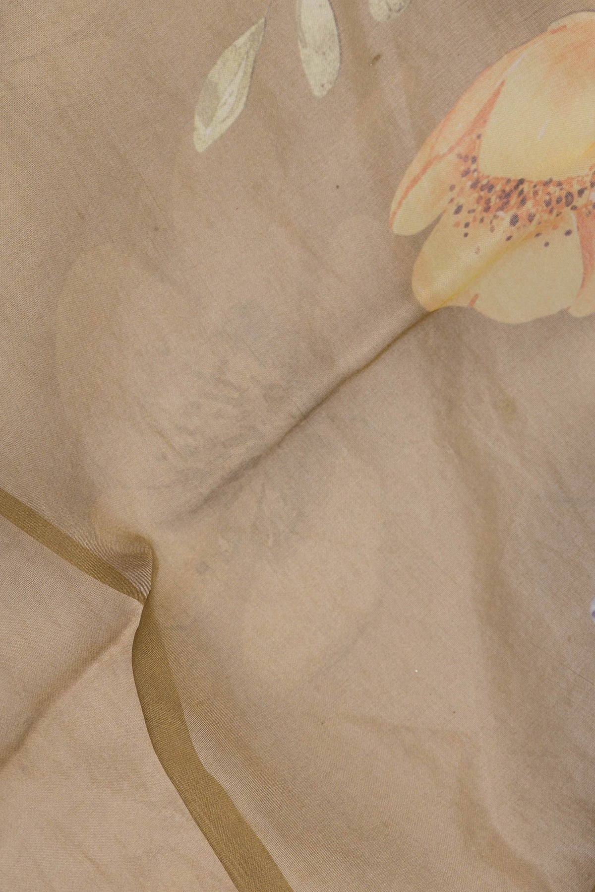 Close up of Mehandi Green Dual Tone Organza Silk Saree with Printed design on the body and Without Border.  displaying folds