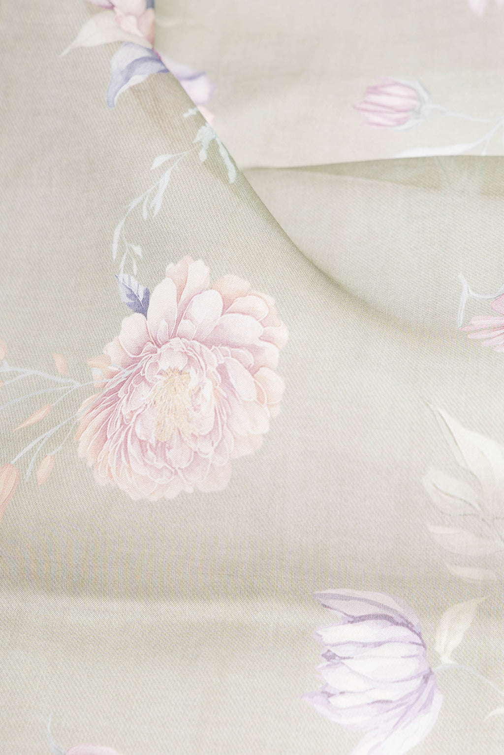 Close up of Sage Green Organza Silk Saree with Floral Print on the body and Without Border.  displaying folds