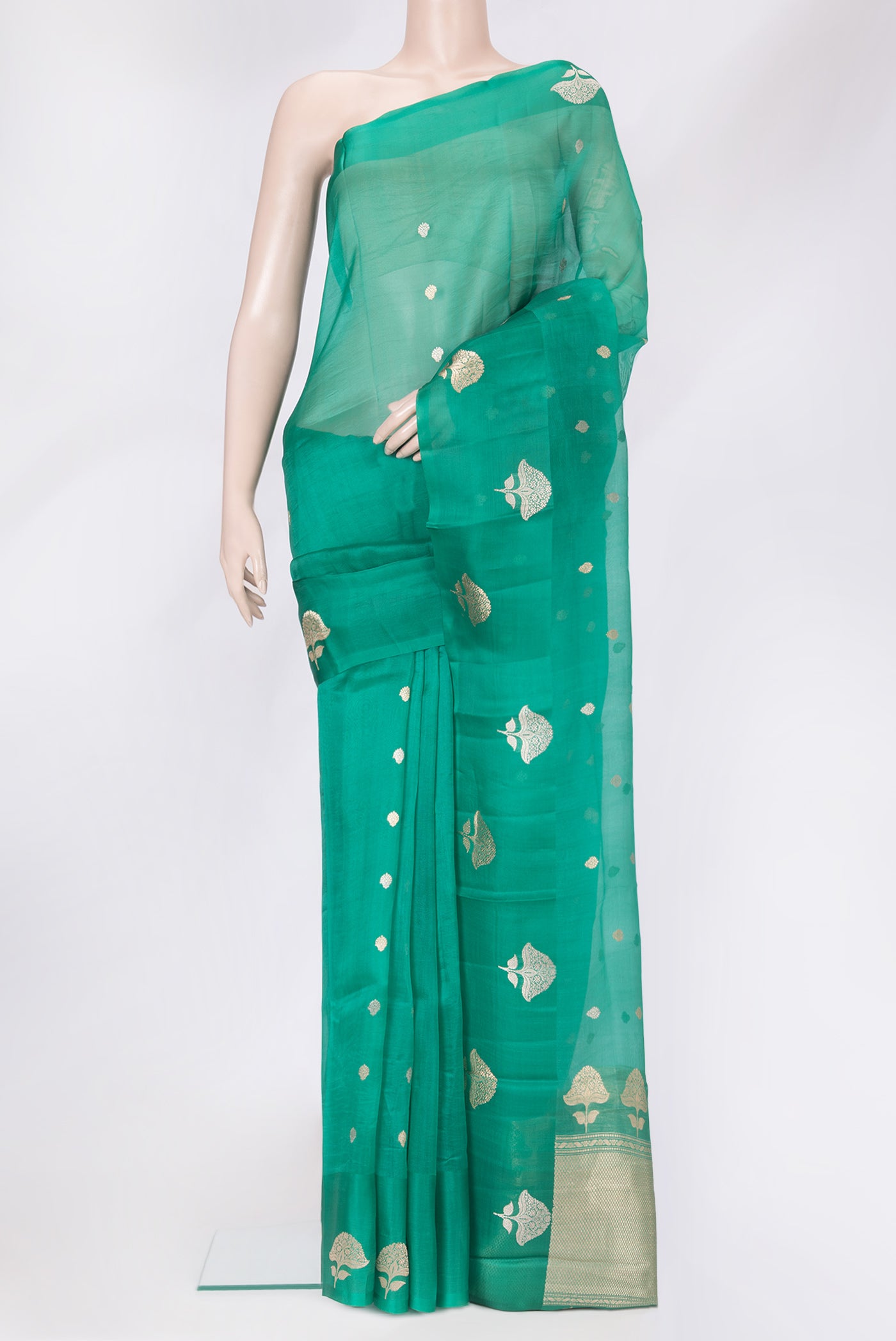 Green Organza Silk Saree with Zari Butta on the body and Fancy Border.  displayed on a mannequin