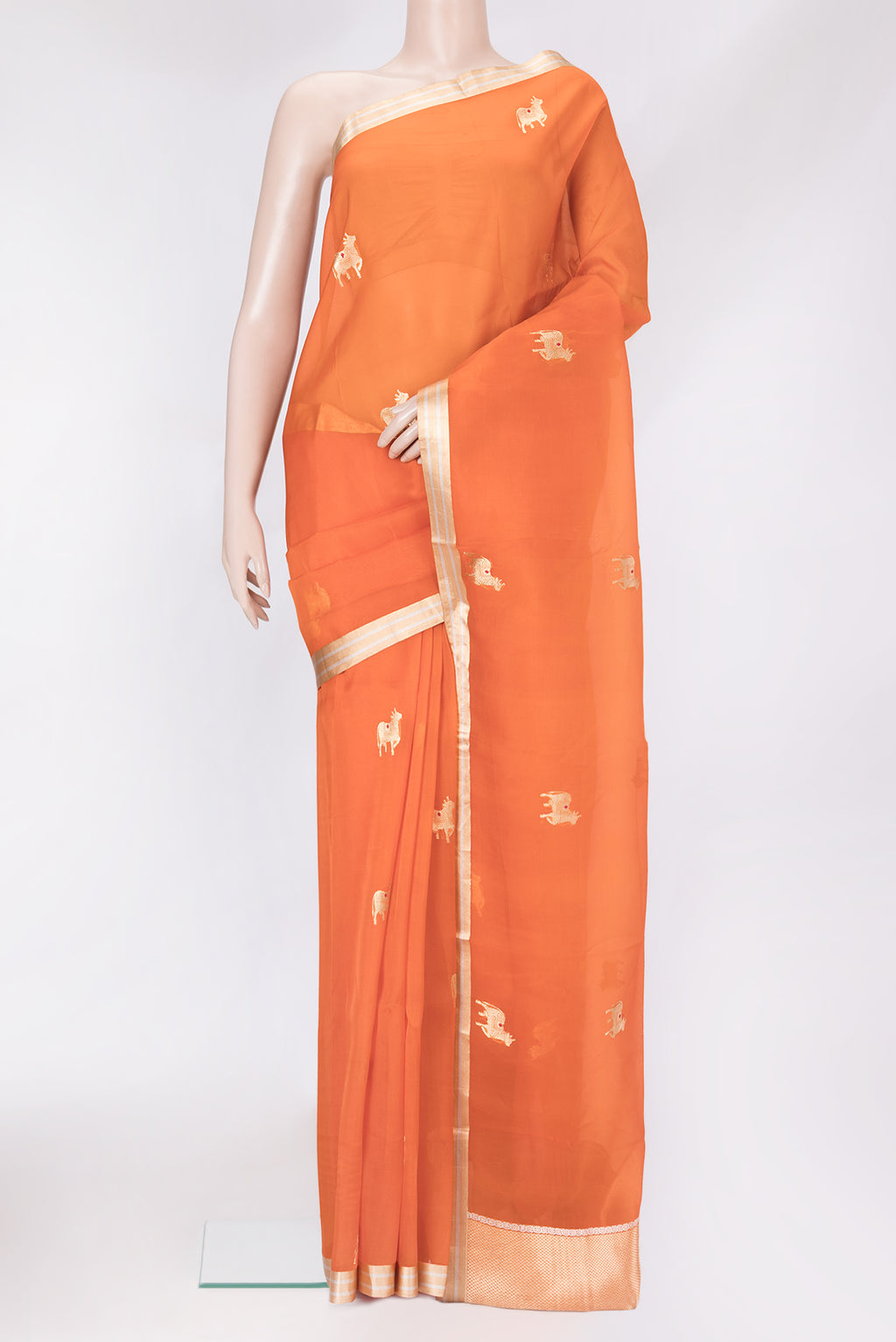 Orange Organza Silk Saree with Zari Butta on the body and Zari Border.  displayed on a mannequin