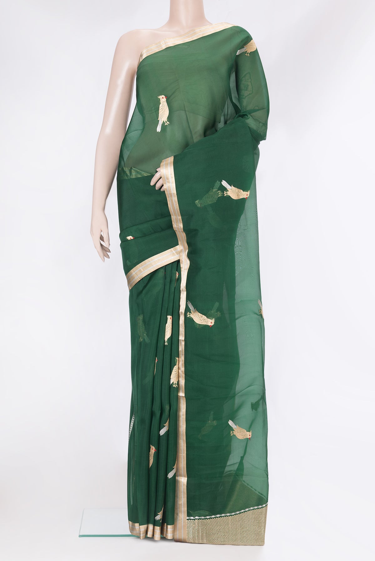Bottle Green Organza Silk Saree with Zari And Thread Butta on the body and Zari Border.  displayed on a mannequin
