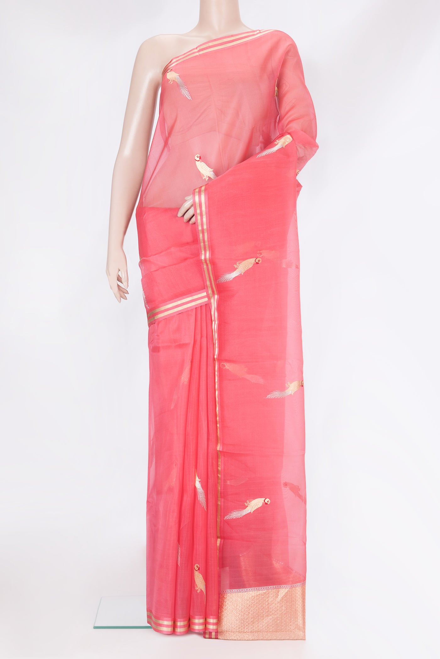 Peach Organza Silk Saree with Zari And Thread Butta on the body and Zari Border.  displayed on a mannequin
