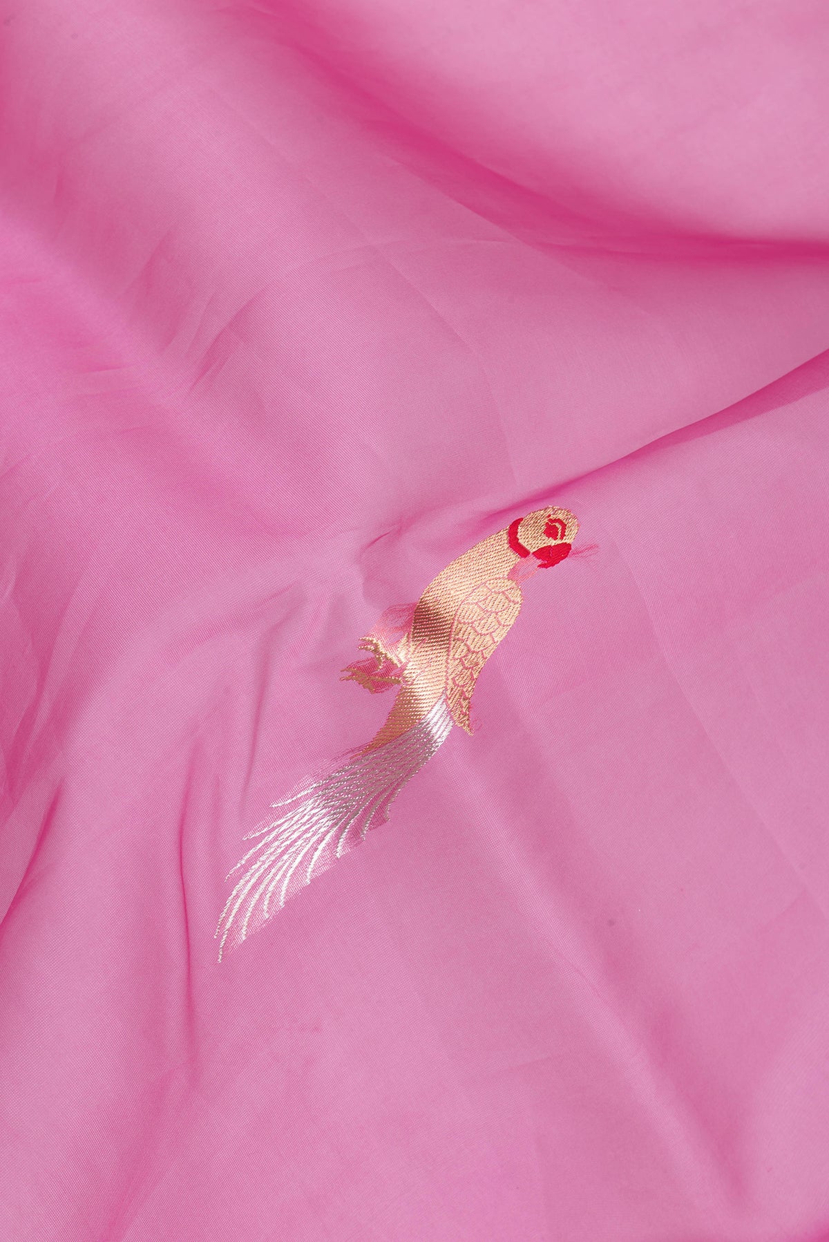 Close up of Pink Organza Silk Saree with Zari And Thread Butta on the body and Zari Border.  displaying folds