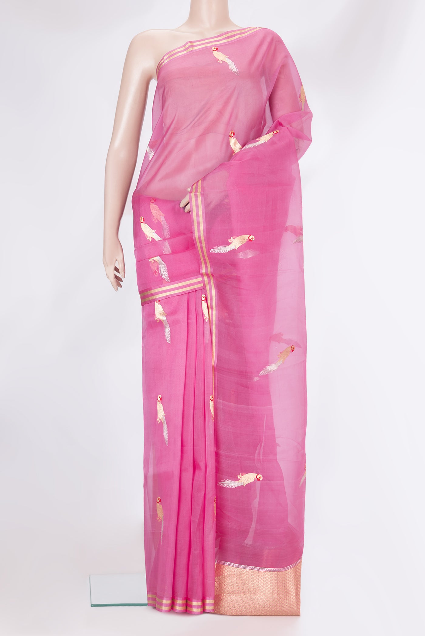 Pink Organza Silk Saree with Zari And Thread Butta on the body and Zari Border.  displayed on a mannequin