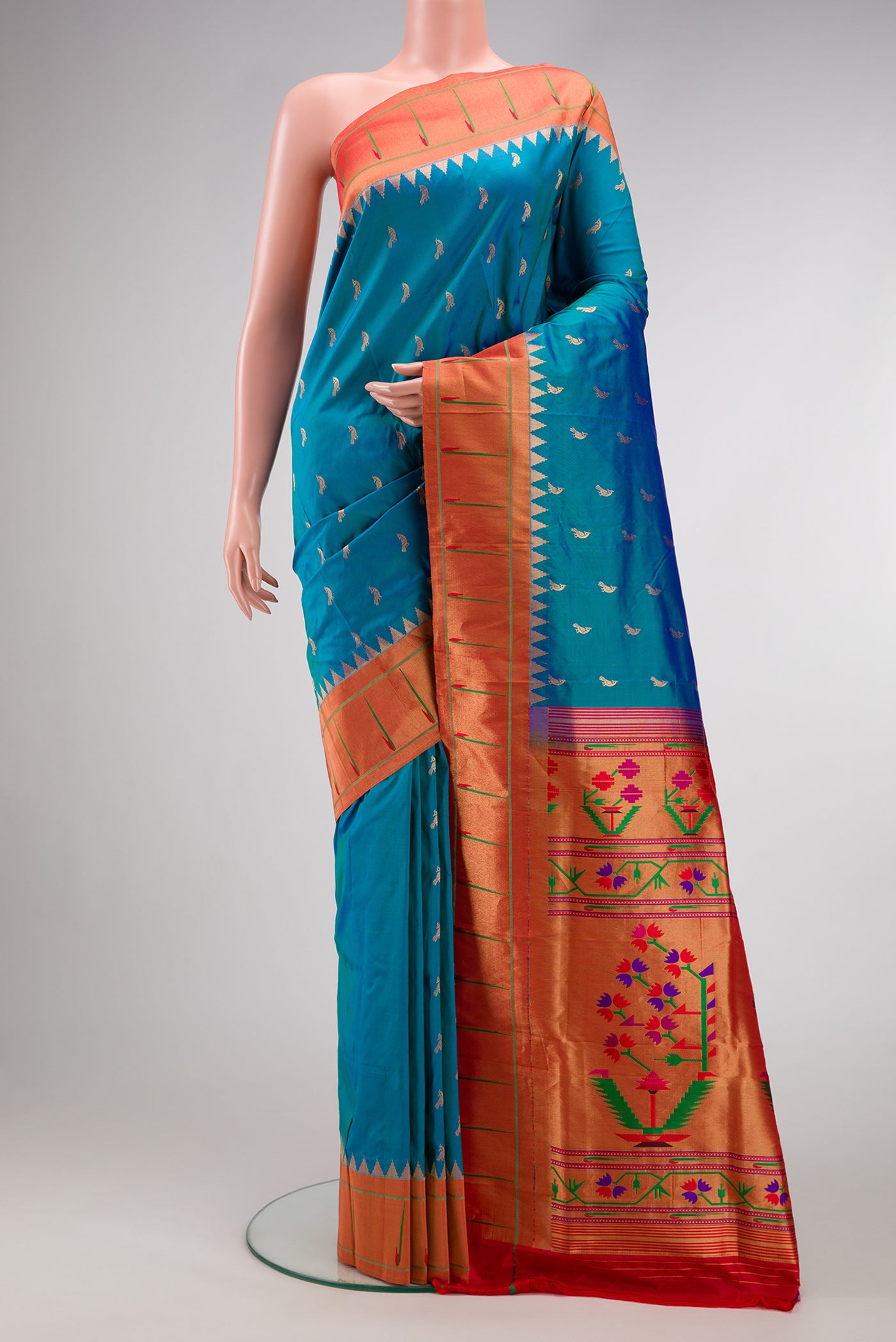 Peacock Blue Dual Tone Paithani Silk Saree with Zari Butta on the body and Paithani Border.  displayed on a mannequin