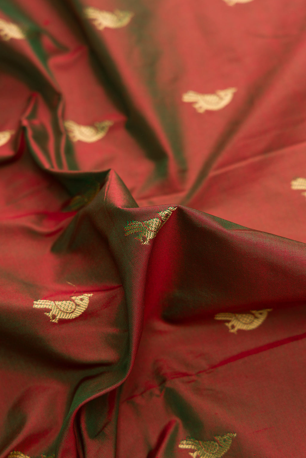 Close up of Mehandi Green Dual Tone Paithani Silk Saree with Zari Butta on the body and Paithani Border.  displaying folds