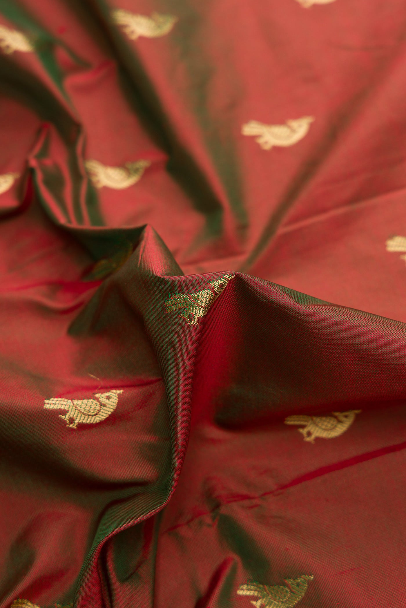Close up of Mehandi Green Dual Tone Paithani Silk Saree with Zari Butta on the body and Paithani Border.  displaying folds