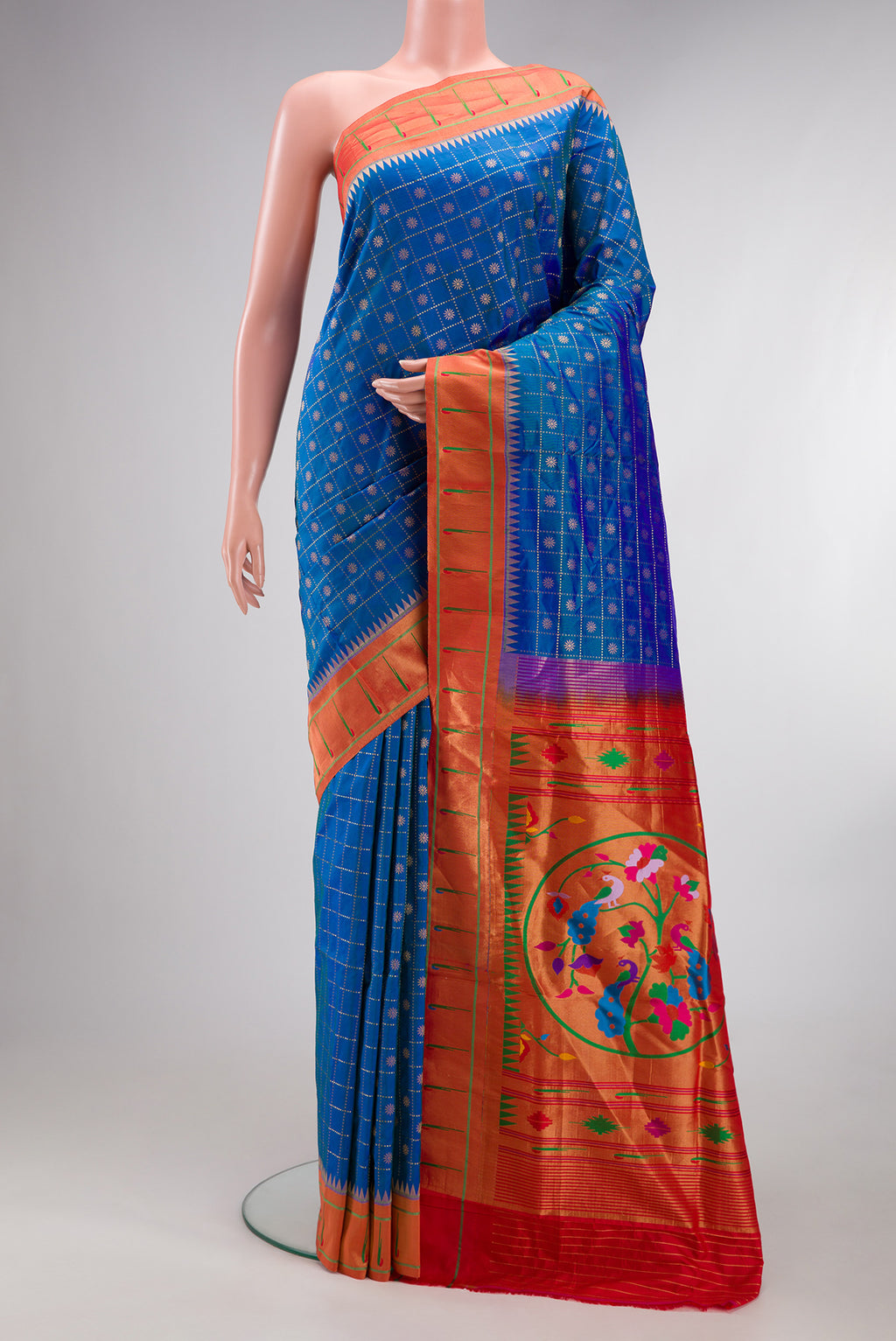 Pure Silk Peacock Blue Dual Tone Paithani Saree with Checked design on the body and Paithani Border.  displayed on a mannequin