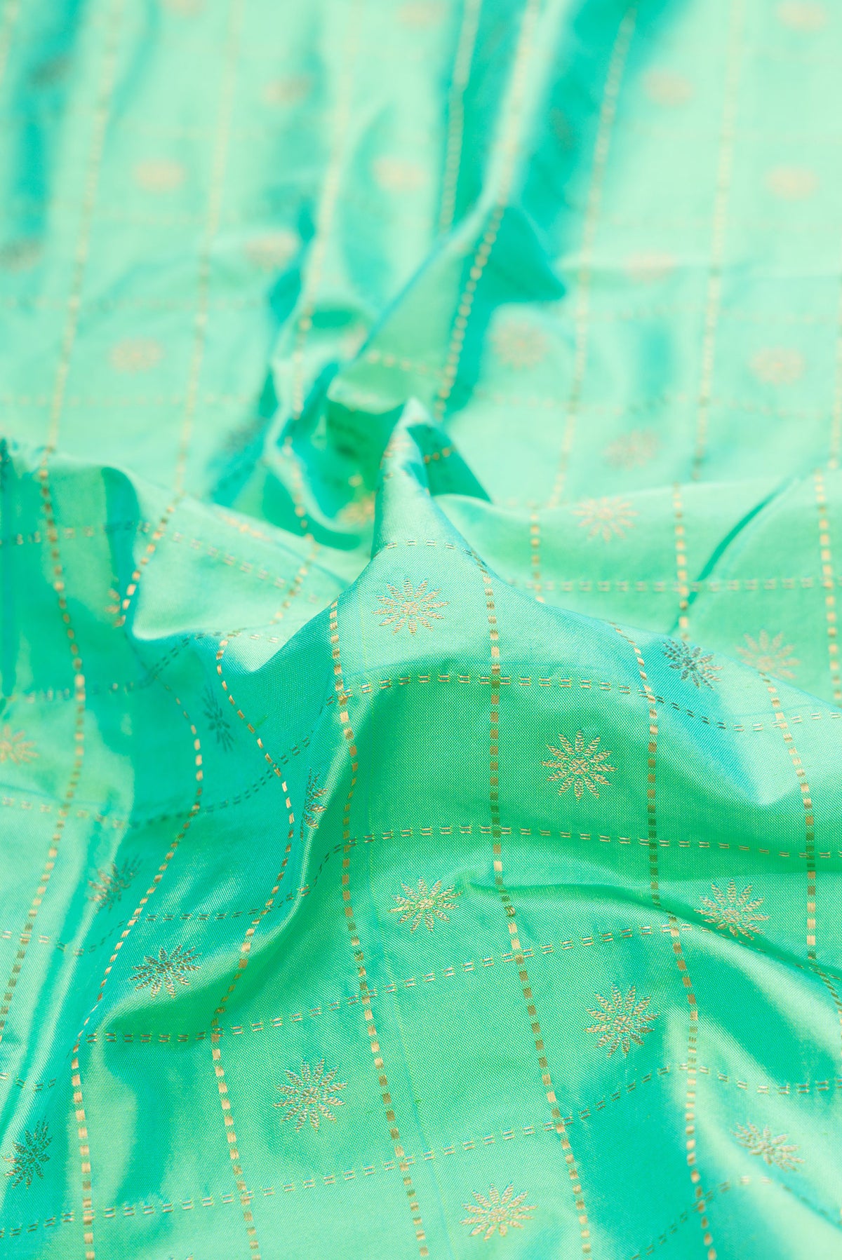 Close up of Pure Silk Sea Green Dual Tone Paithani Saree with Checked design on the body and Paithani Border.  displaying folds