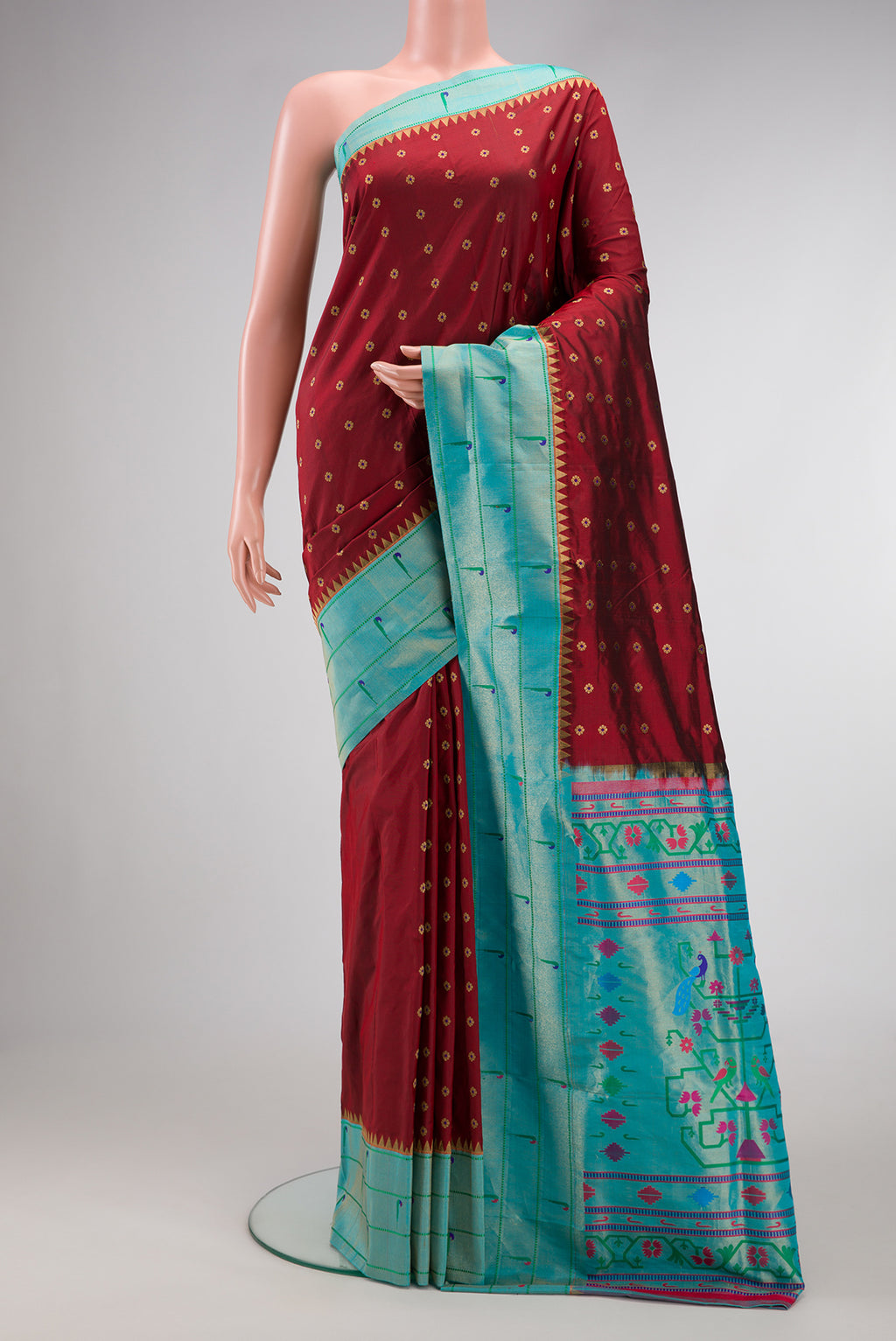 Maroon Dual Tone Paithani Silk Saree with Zari Butta on the body and Paithani Border.  displayed on a mannequin