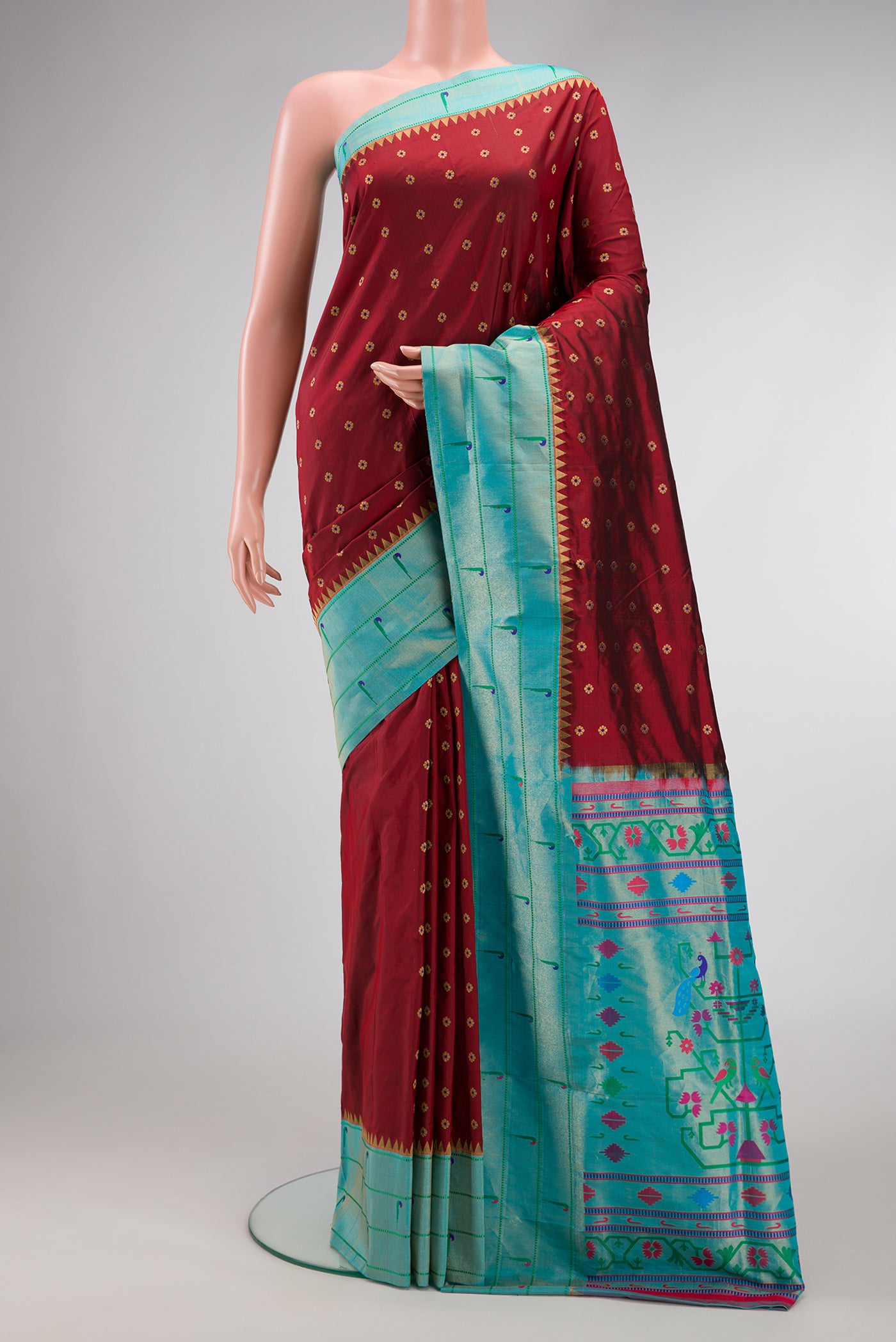 Maroon Dual Tone Paithani Silk Saree with Zari Butta on the body and Paithani Border.  displayed on a mannequin