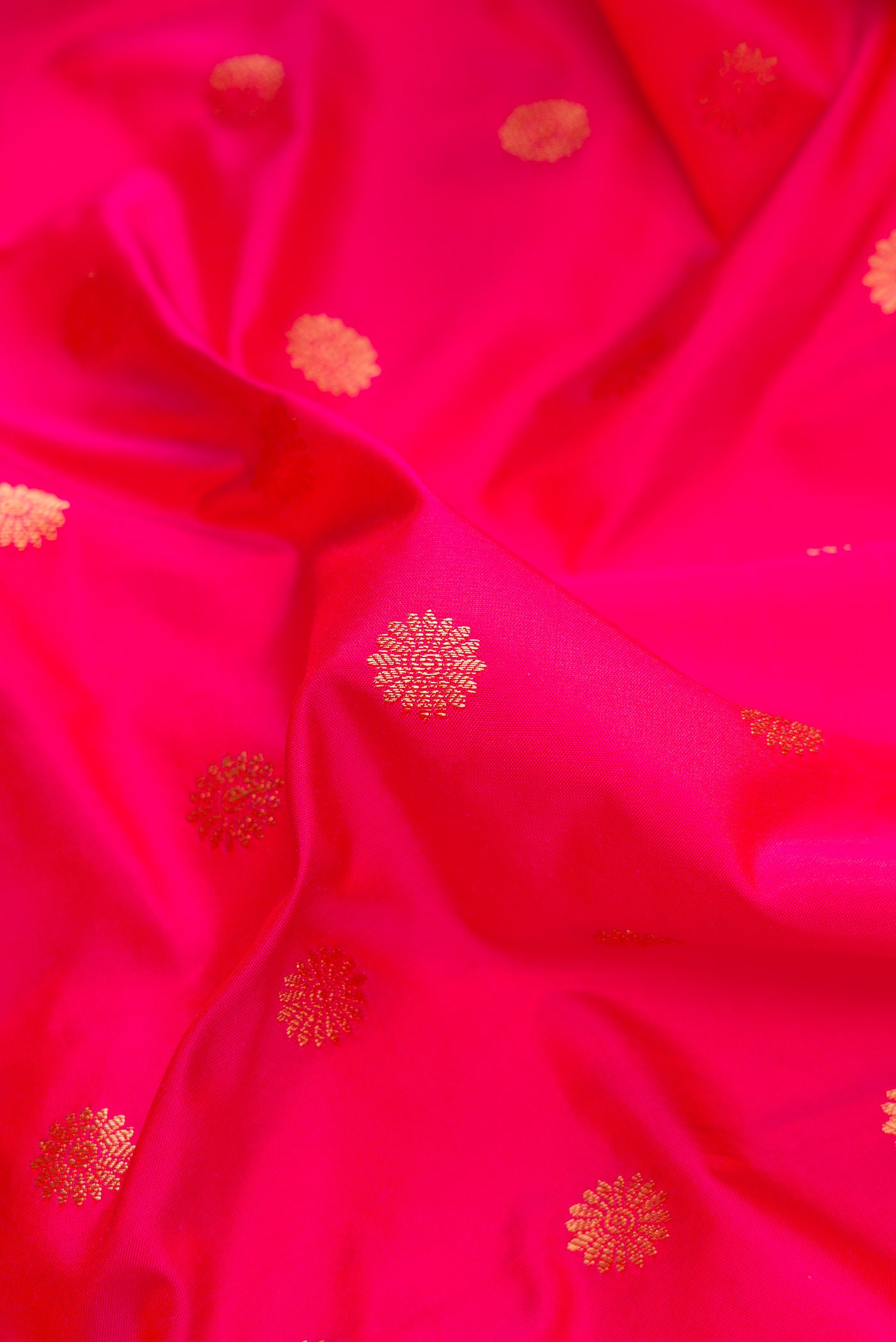 Close up of Pink Dual Tone Paithani Silk Saree with Zari Butta on the body and Paithani Border.  displaying folds