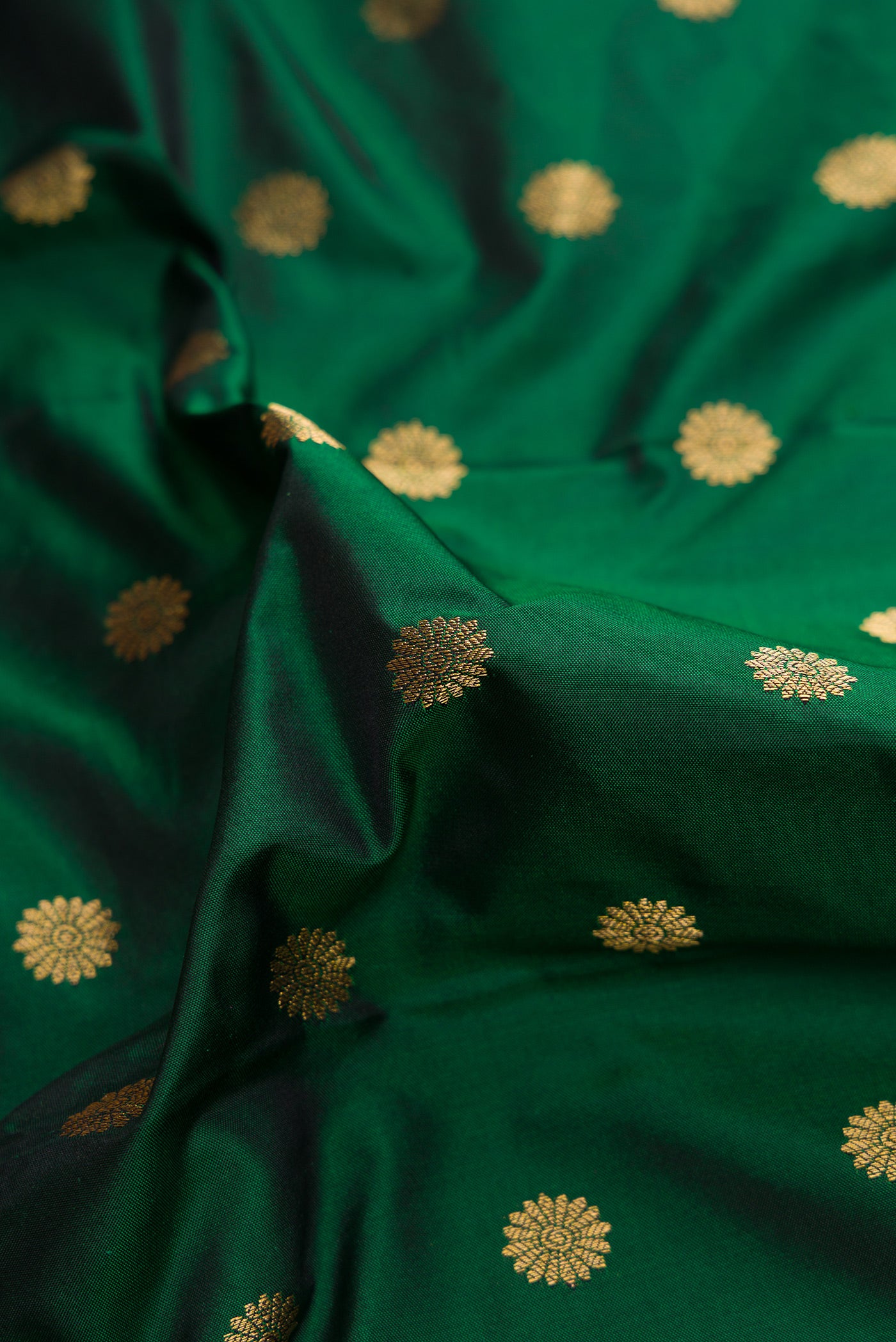 Close up of Bottle Green Dual Tone Paithani Silk Saree with Zari Butta on the body and Paithani Border.  displaying folds