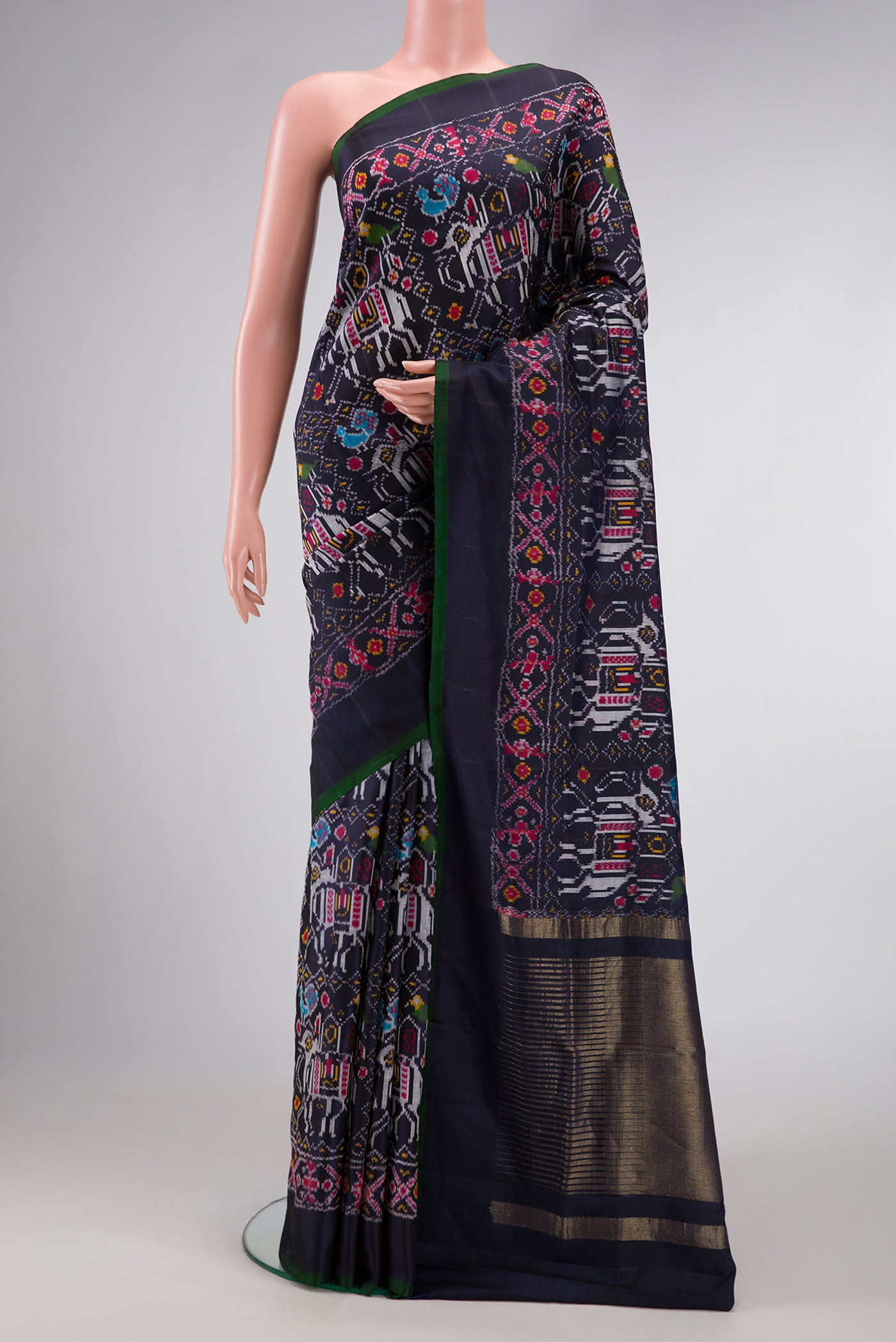 Navy Blue Dual Tone Double Ikat Saree with Ikat Print on the body and Plain Border.  displayed on a mannequin
