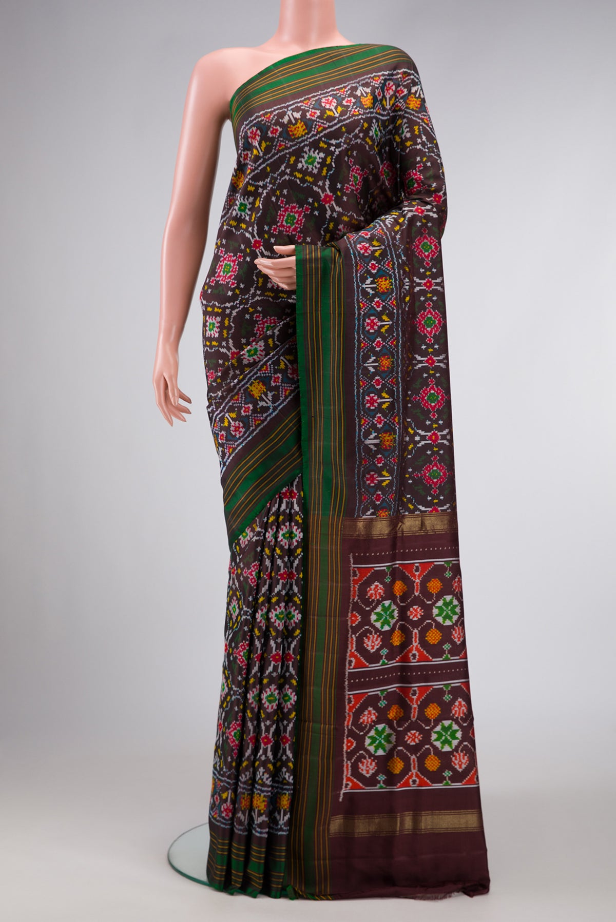 Black Dual Tone Double Ikat Saree with Ikat Print on the body and Thread Border.  displayed on a mannequin