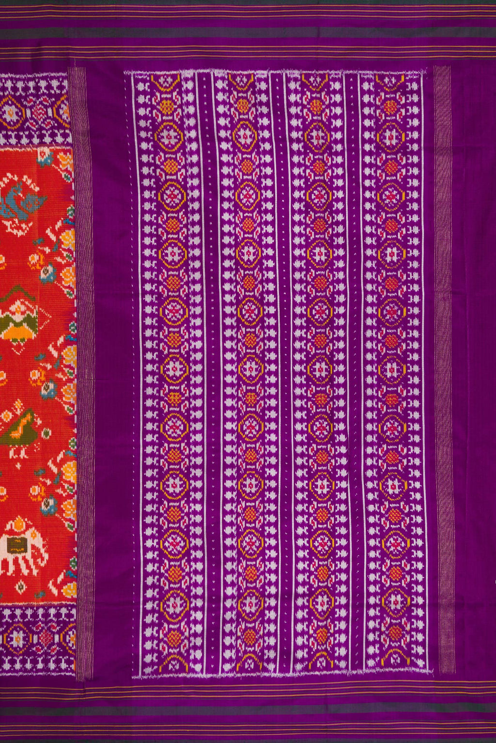 Close up image of the pallu of Brick Orange Dual Tone Double Ikat Saree with Ikat Print on the body and Zari Border. 
