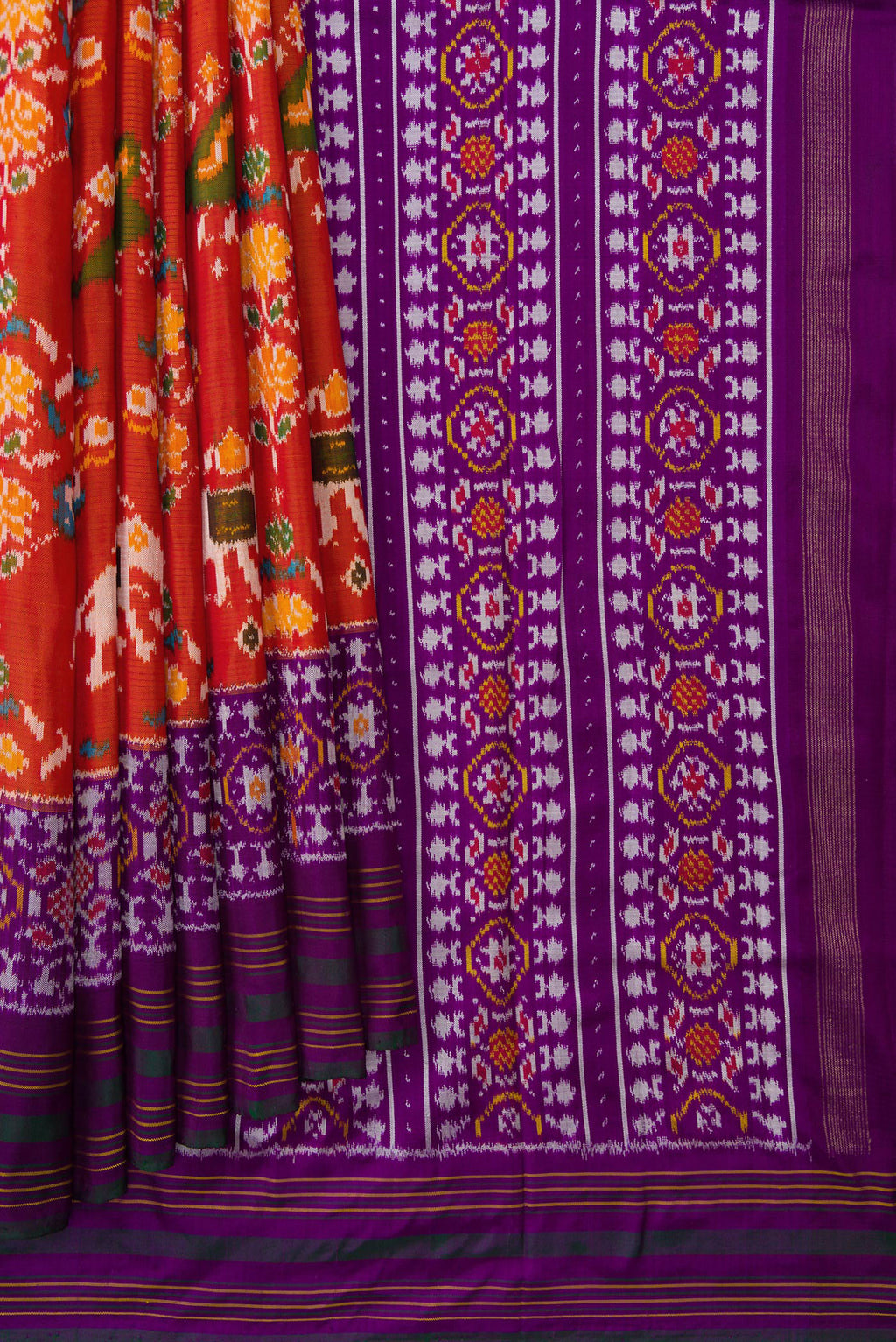 Pleats and pallu of Brick Orange Dual Tone Double Ikat Saree with Ikat Print on the body and Zari Border. 