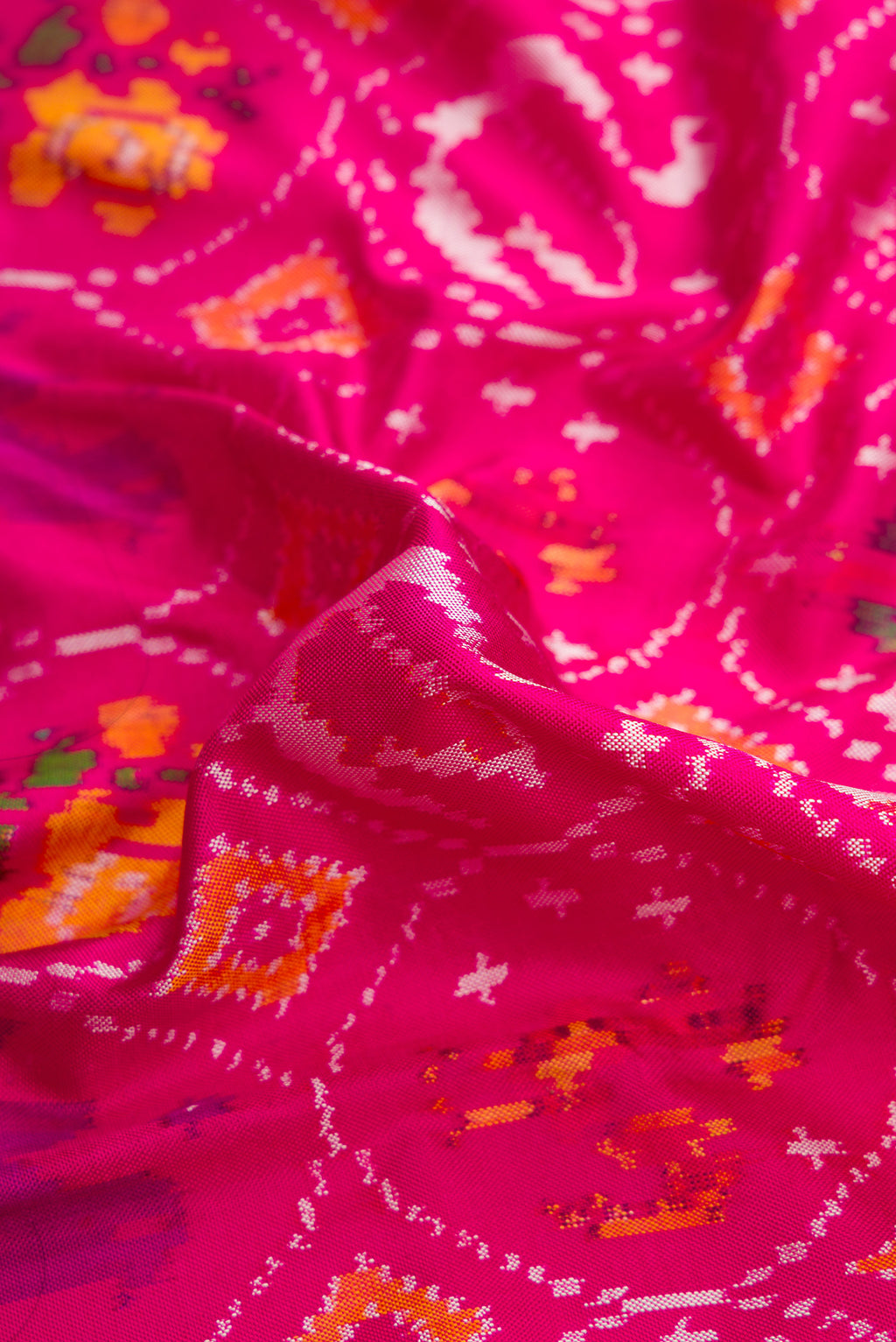 Close up of Pink Dual Tone Double Ikat Saree with Ikat Print on the body and Ikat Border.  displaying folds