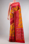 Mustard Dual Tone Double Ikat Saree with Ikat Print on the body and Ikat Border.  displayed on a mannequin