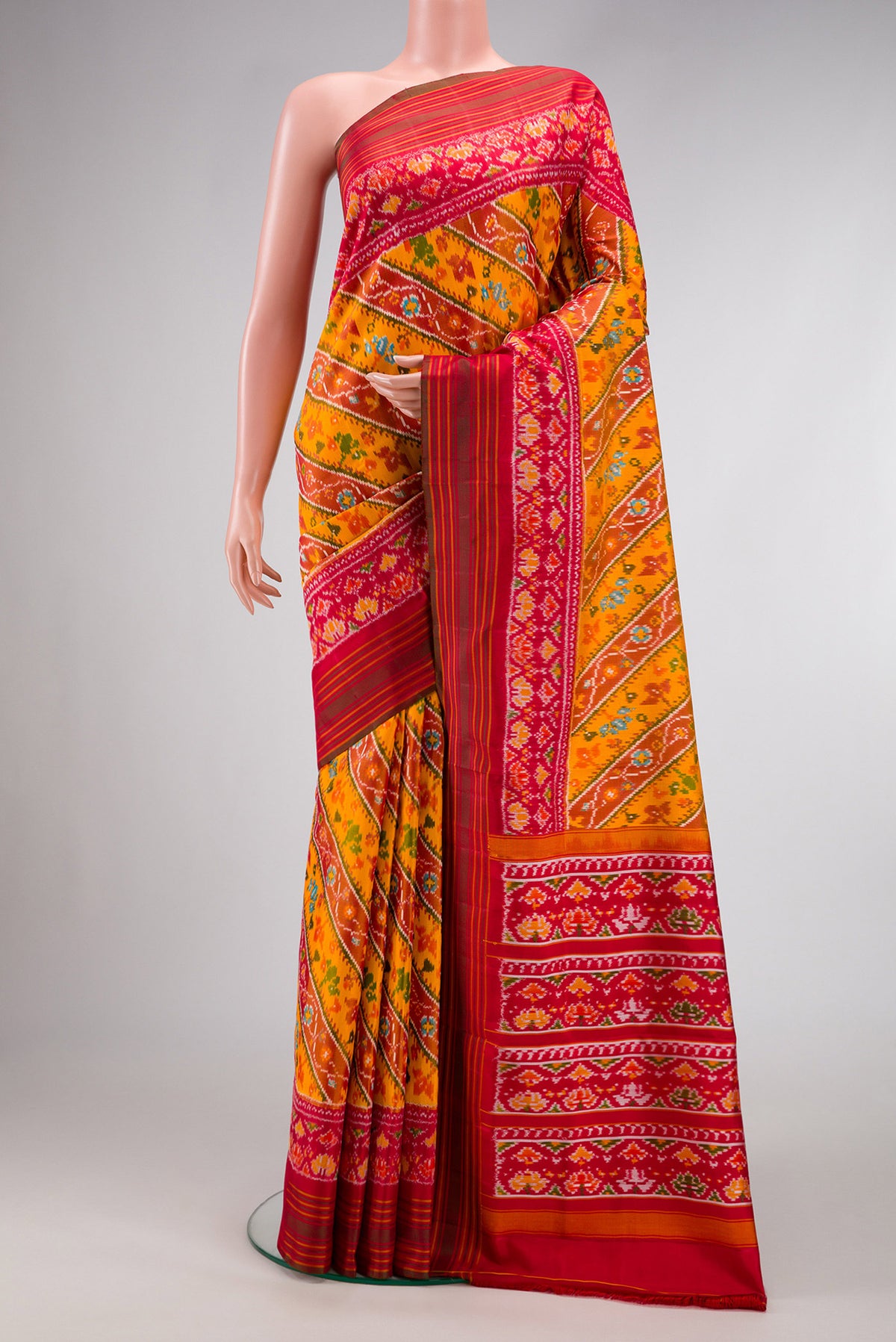 Mustard Dual Tone Double Ikat Saree with Ikat Print on the body and Ikat Border.  displayed on a mannequin