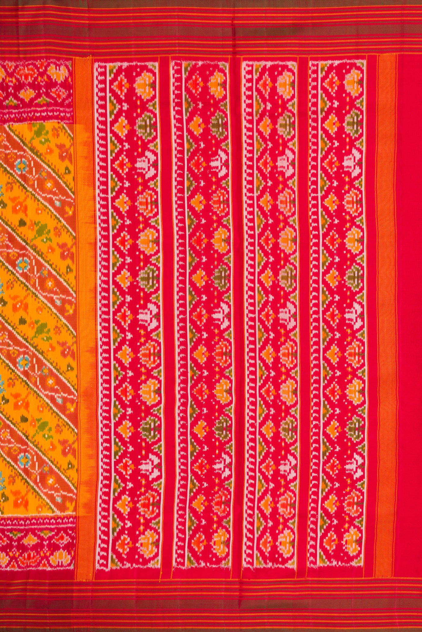Close up image of the pallu of Mustard Dual Tone Double Ikat Saree with Ikat Print on the body and Ikat Border. 