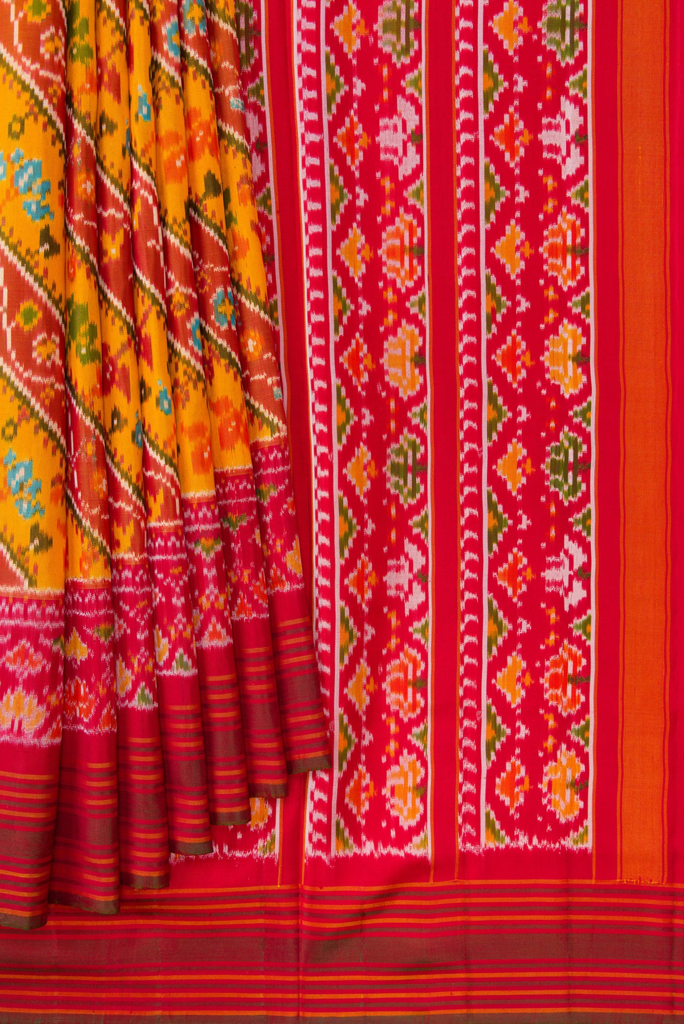 Pleats and pallu of Mustard Dual Tone Double Ikat Saree with Ikat Print on the body and Ikat Border. 