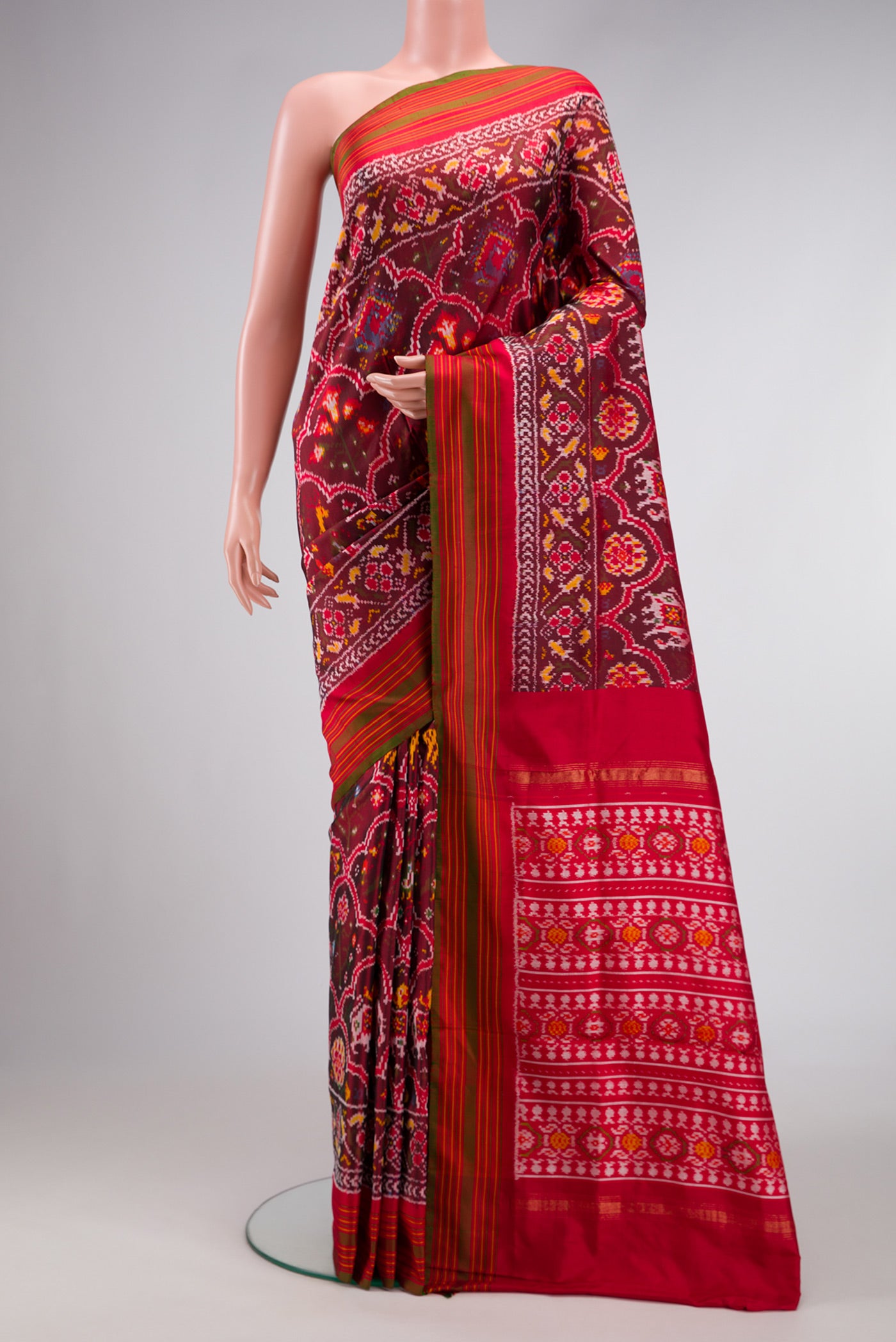Maroon Dual Tone Double Ikat Saree with Ikat Print on the body and Zari Border.  displayed on a mannequin