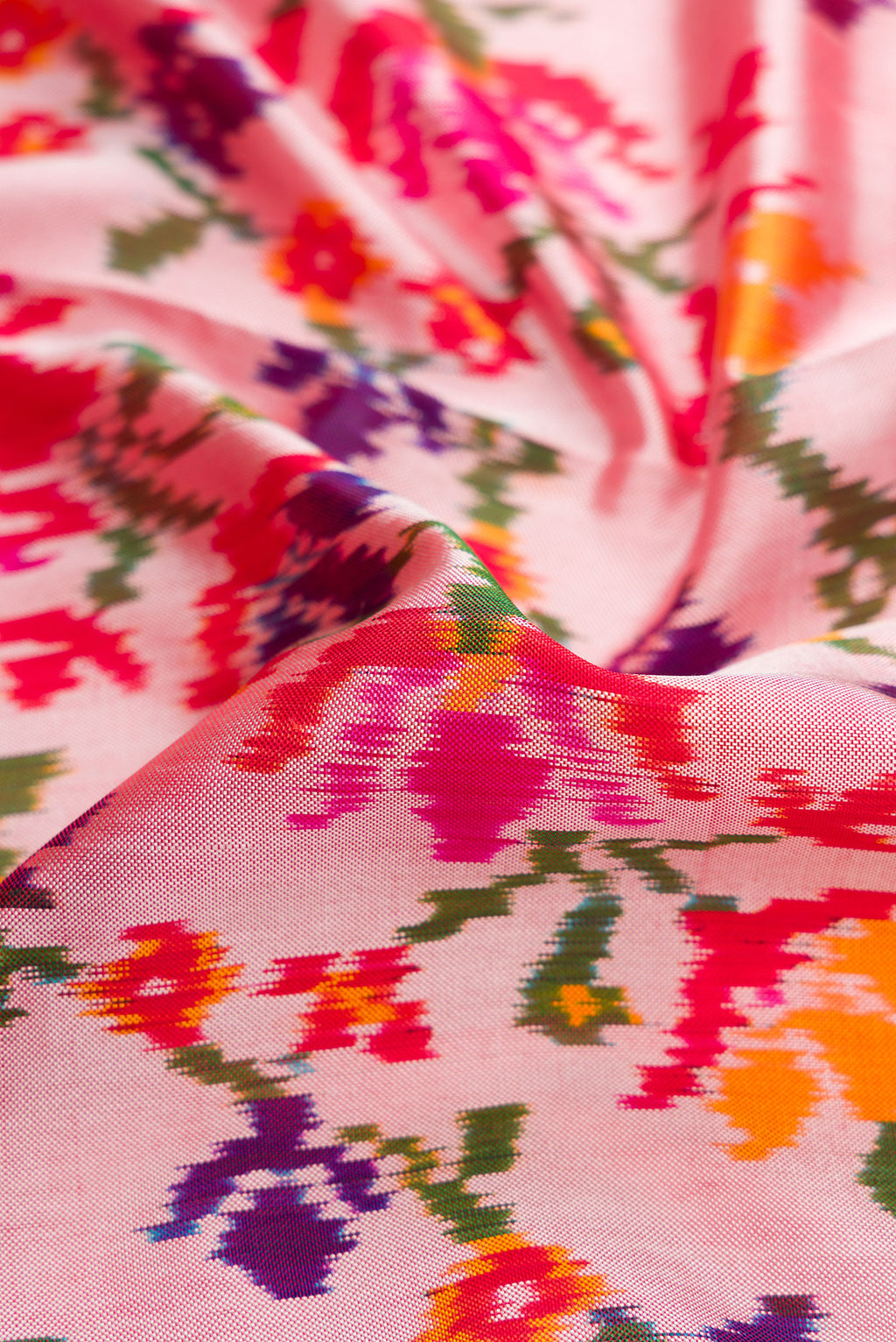 Close up of Pink Dual Tone Double Ikat Saree with Ikat Print on the body and Ikat Border.  displaying folds