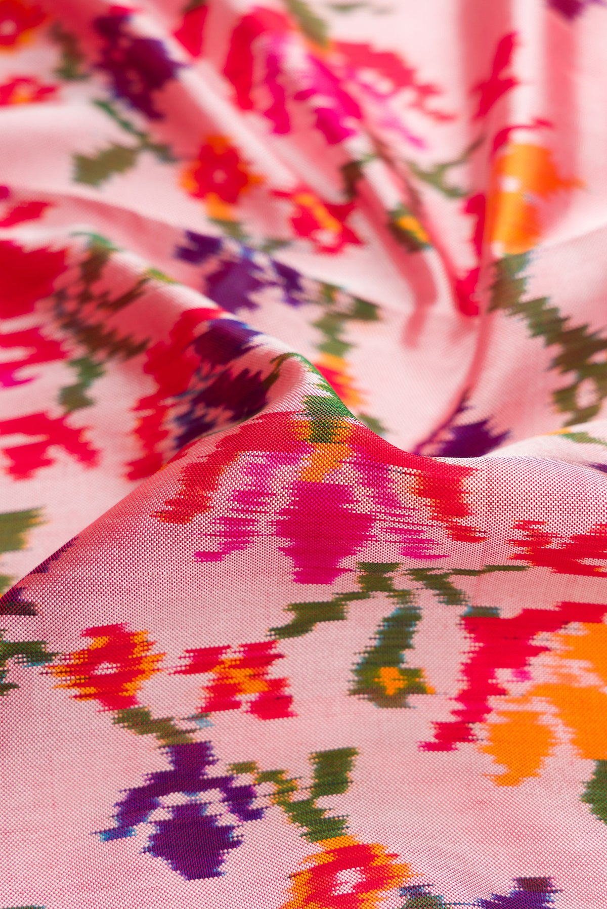 Close up of Pink Dual Tone Double Ikat Saree with Ikat Print on the body and Ikat Border.  displaying folds