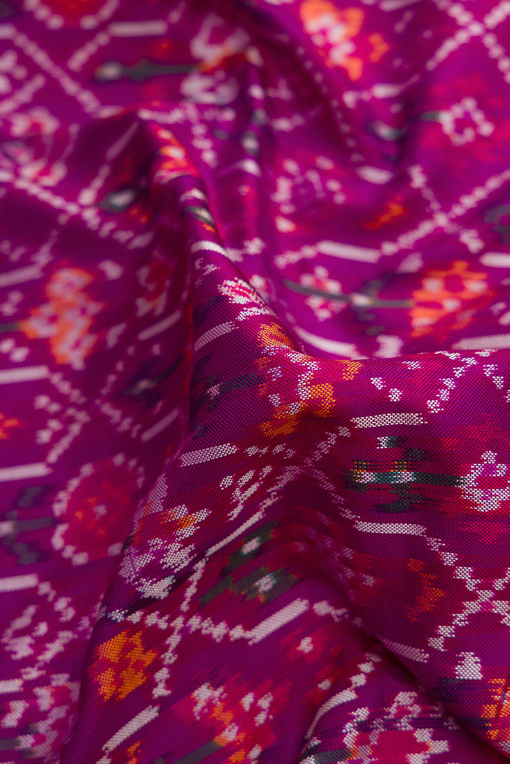 Close up of Purple Dual Tone Double Ikat Saree with Ikat Print on the body and Zari Border.  displaying folds