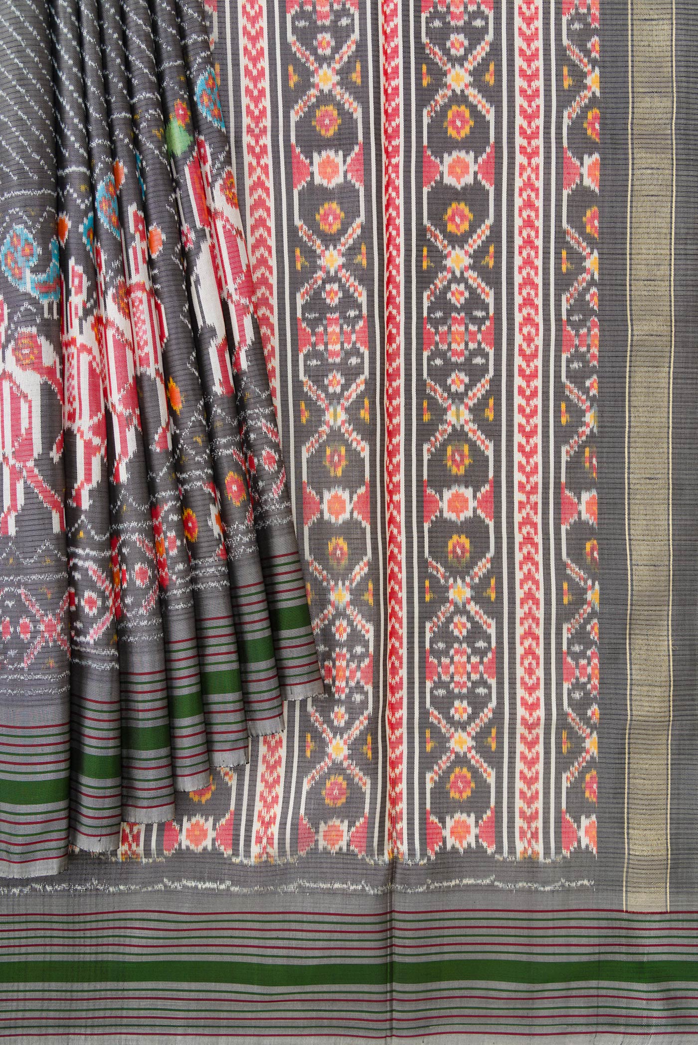 Pleats and pallu of Grey Dual Tone Double Ikat Saree with Ikat Print on the body and Ikat Border. 
